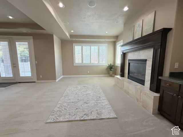 Spacious living area featuring a built-in fireplace with a dark wood mantle and a tile surround