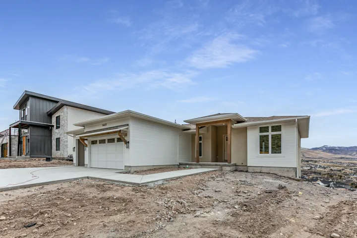 Contemporary exterior featuring a white siding and stucco facade