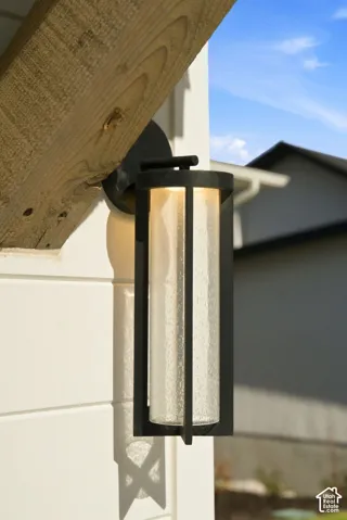 Outdoor wall lantern with a black frame and textured glass