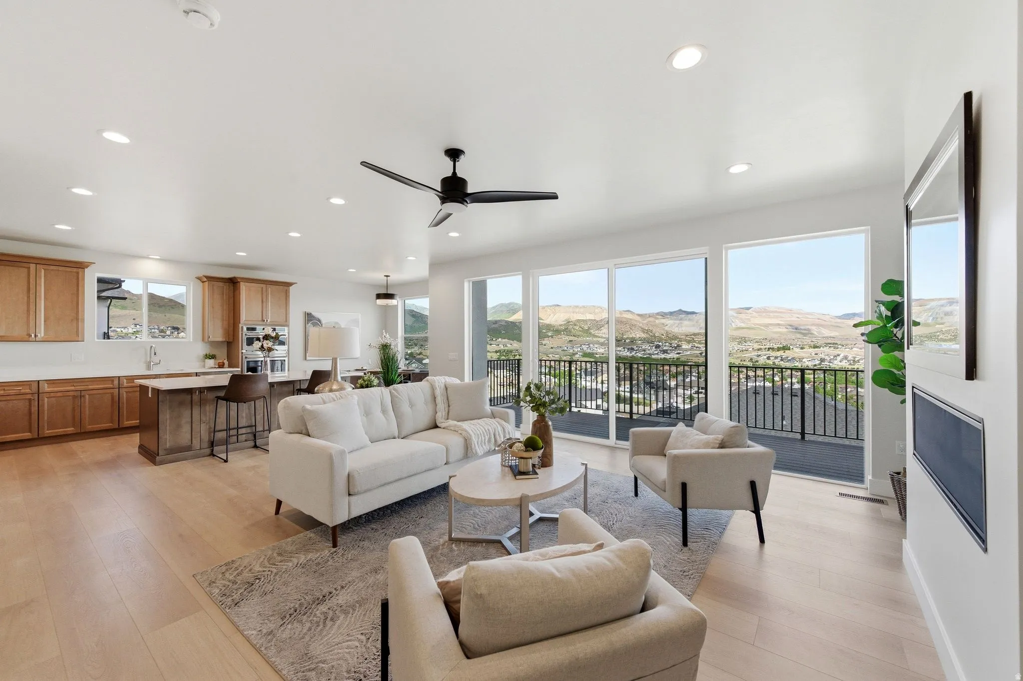 Open-concept living space featuring wood-finish flooring and recessed lighting