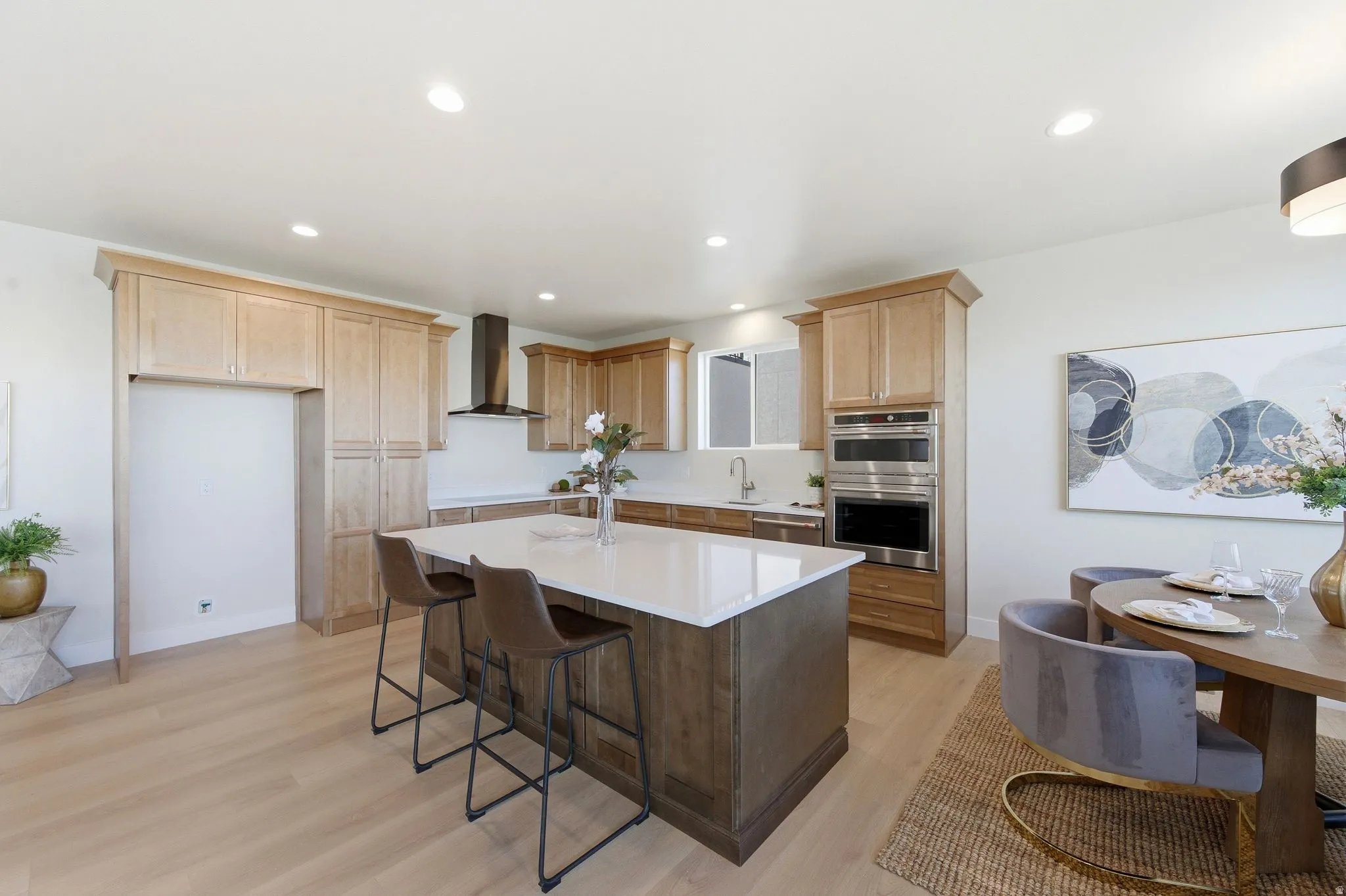 Open concept kitchen featuring an expansive center island with a white countertop