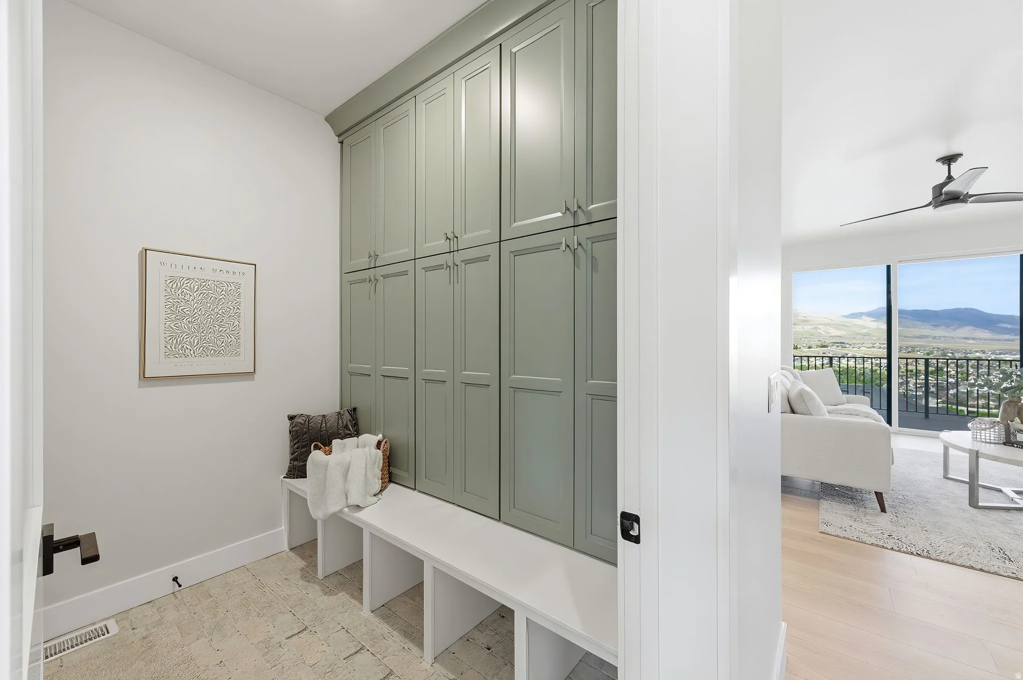 Custom built-in cabinetry in a soft sage finish with brushed nickel hardware