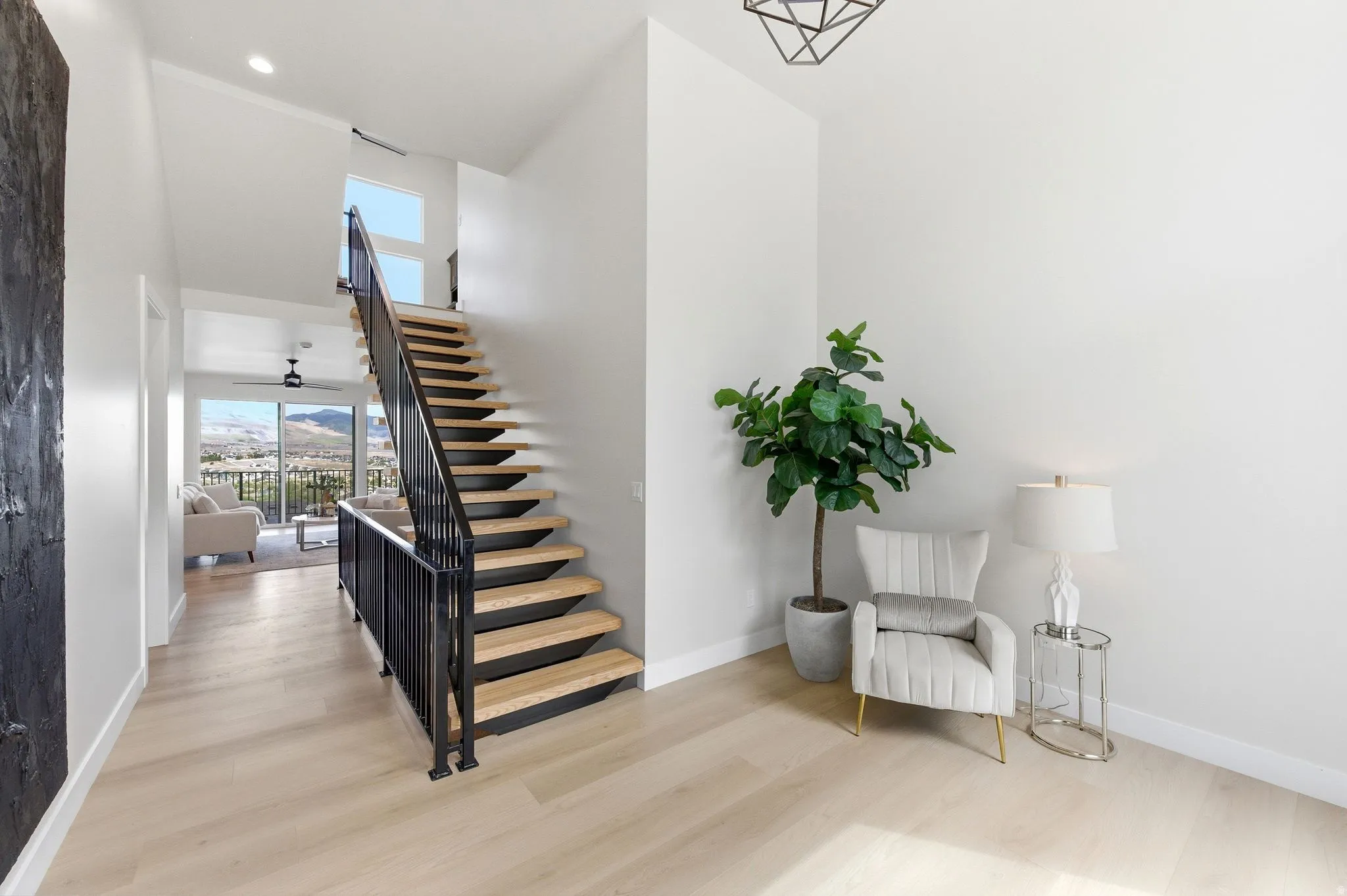 Floating staircase with light wood treads and black metal railing