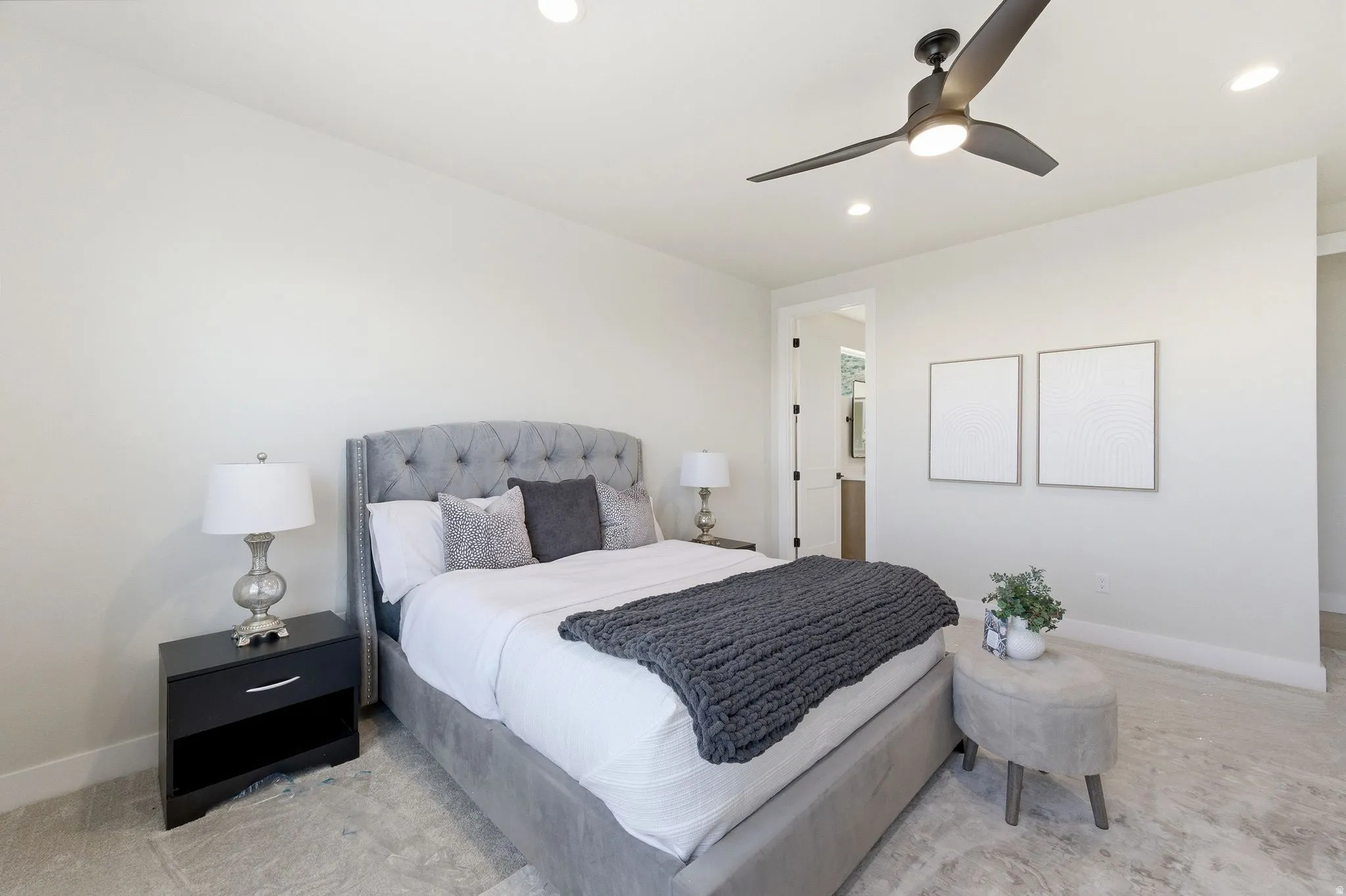 Bedroom featuring light-toned walls, recessed lighting, and a dark-toned ceiling fan