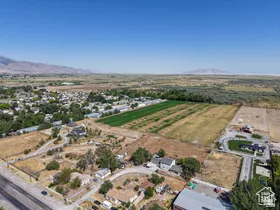 Expansive aerial perspective showcasing a residential area bordered by cultivated fields