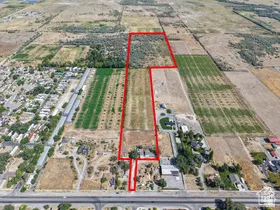 Expansive undeveloped land parcel with varied terrain, including cultivated fields and wooded areas