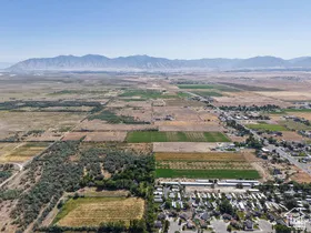 Expansive aerial view showcasing mountainous terrain, agricultural land, and residential clusters