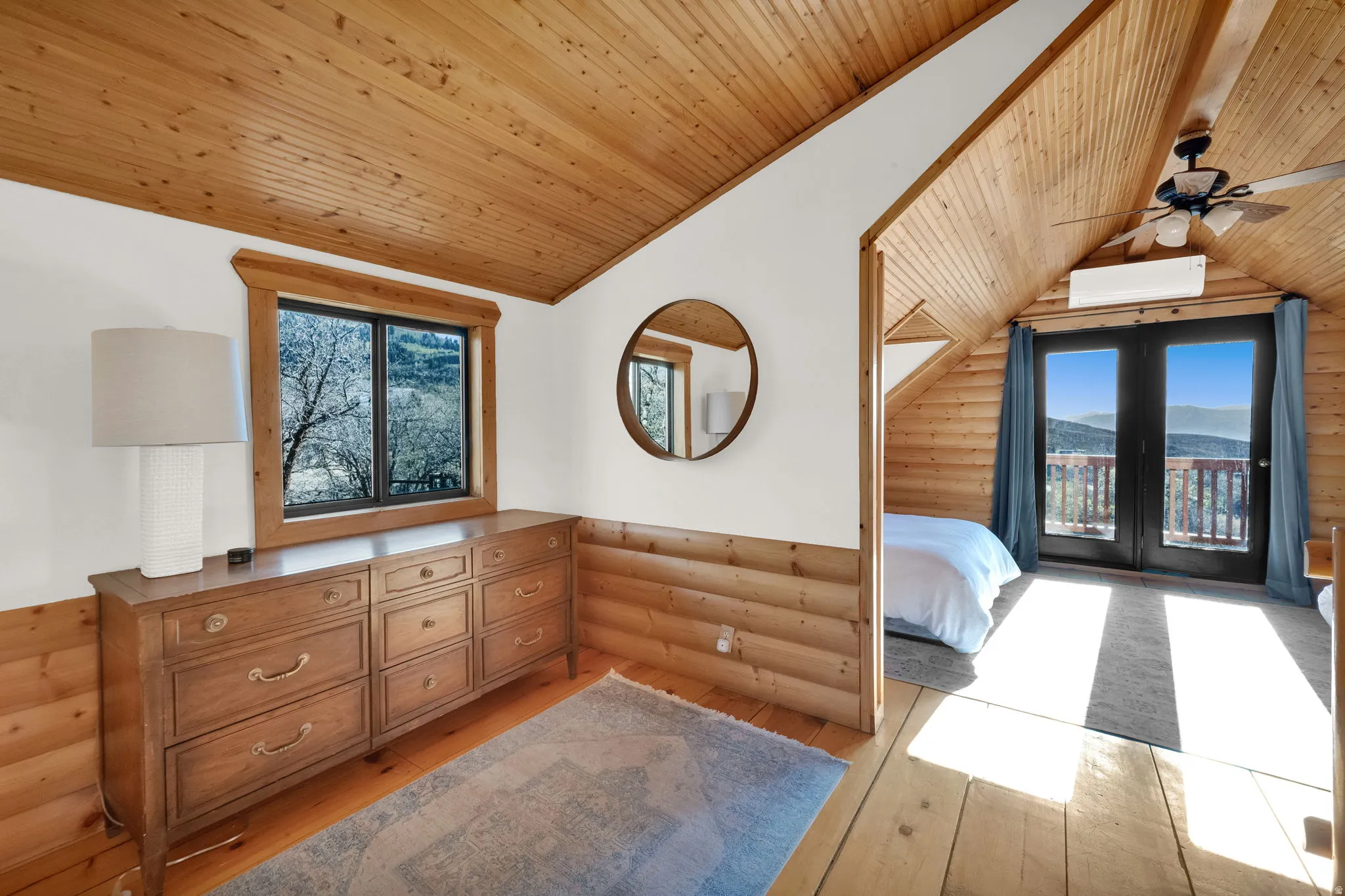 Sloped wood-finish ceiling and walls with exposed beams