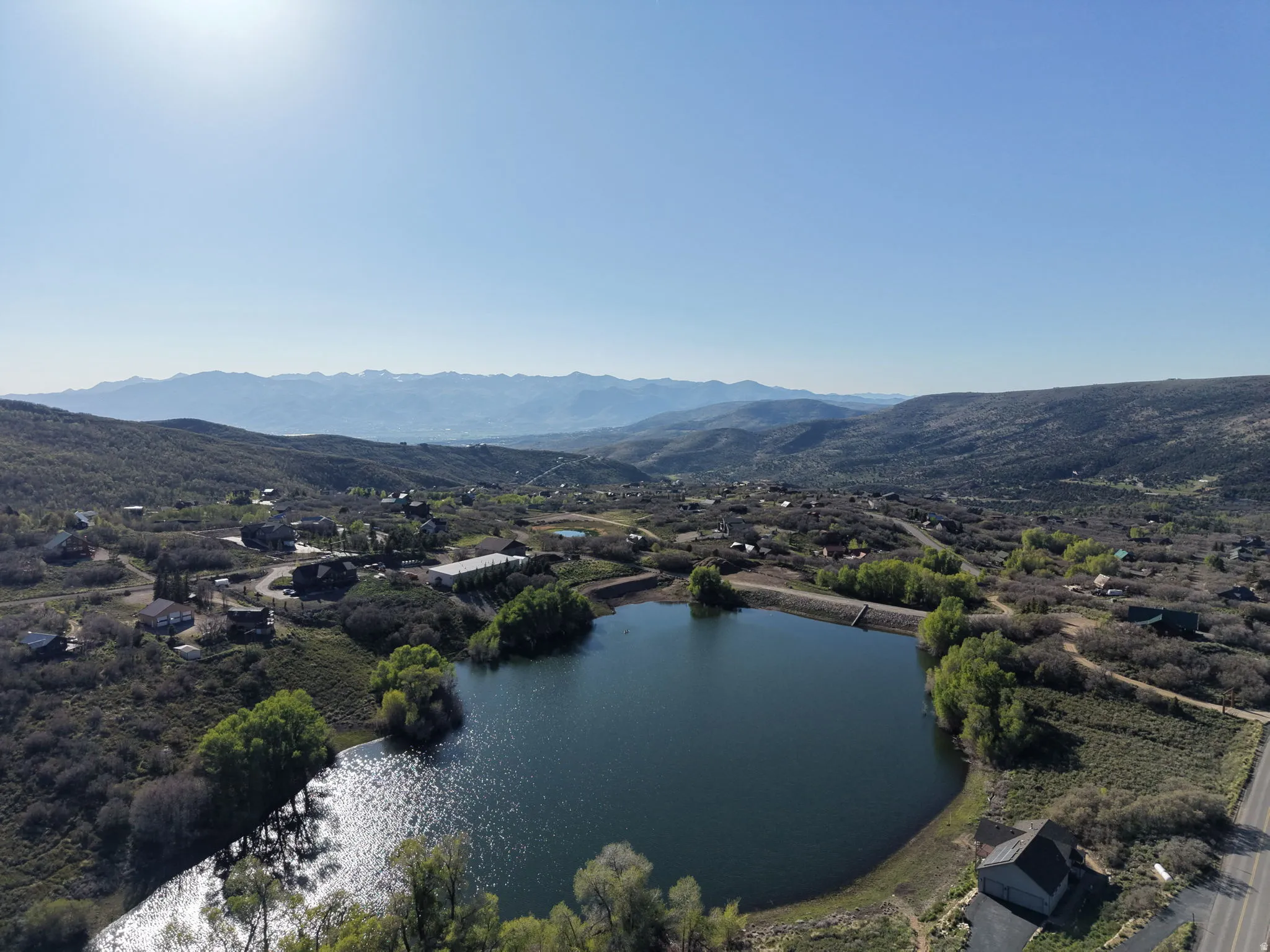 Aerial perspective showcasing a serene body of water surrounded by a verdant landscape