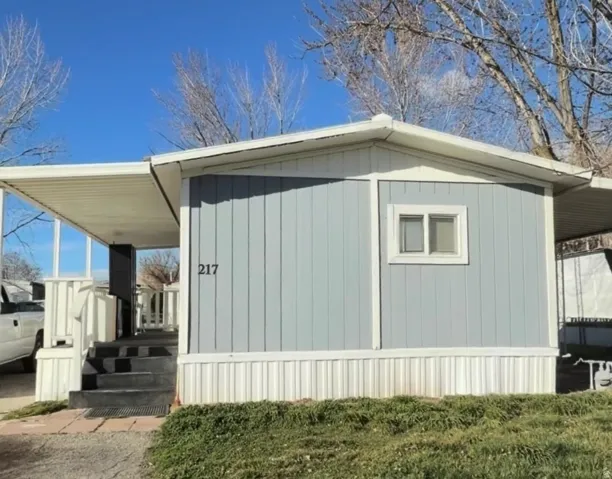 Light blue vertical siding exterior with white trim