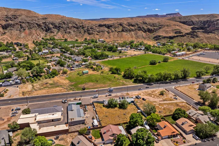 Aerial perspective showcasing residential properties and green spaces framed by natural rock formations