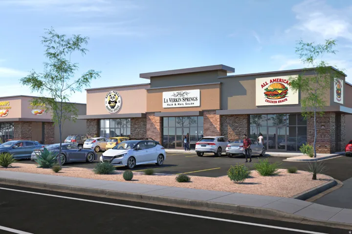 Artistic Rendering - Modern commercial complex featuring stone veneer and stucco exteriors, large storefront windows, dedicated signage areas, ample surface parking, and desert-style landscaping