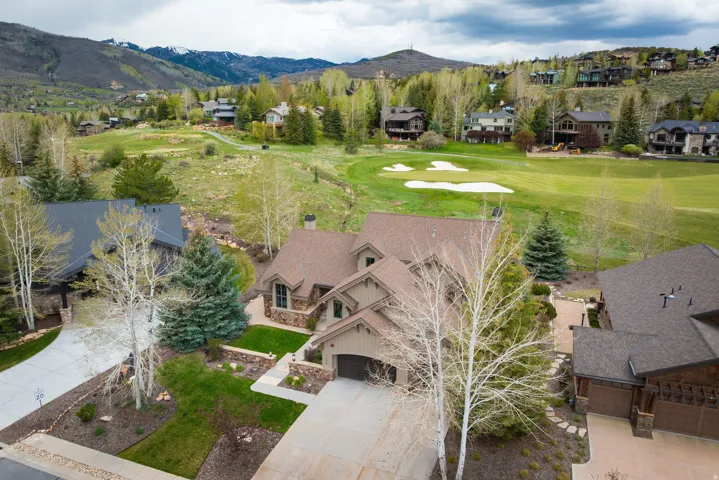 Craftsman-style residence featuring a prominent gable roof and stone accents