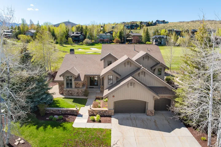 Craftsman-style residence featuring stone accents and vertical siding