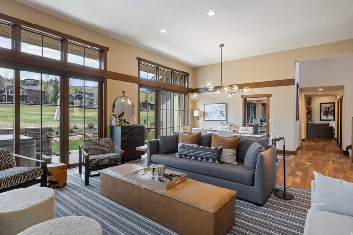 Spacious open-concept living area featuring a vaulted ceiling and extensive natural light
