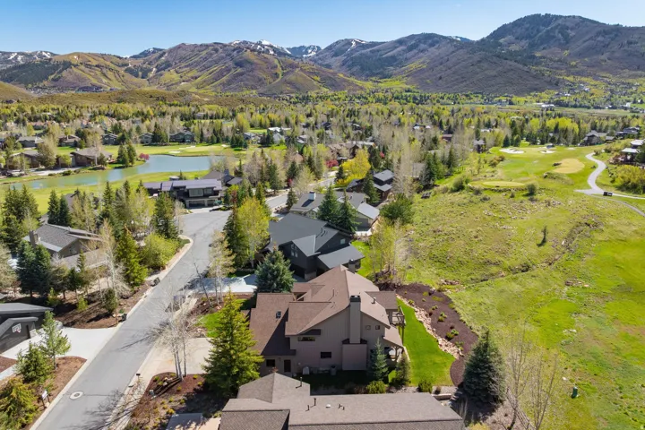 Expansive mountain landscape featuring a golf course, pond, and residential properties