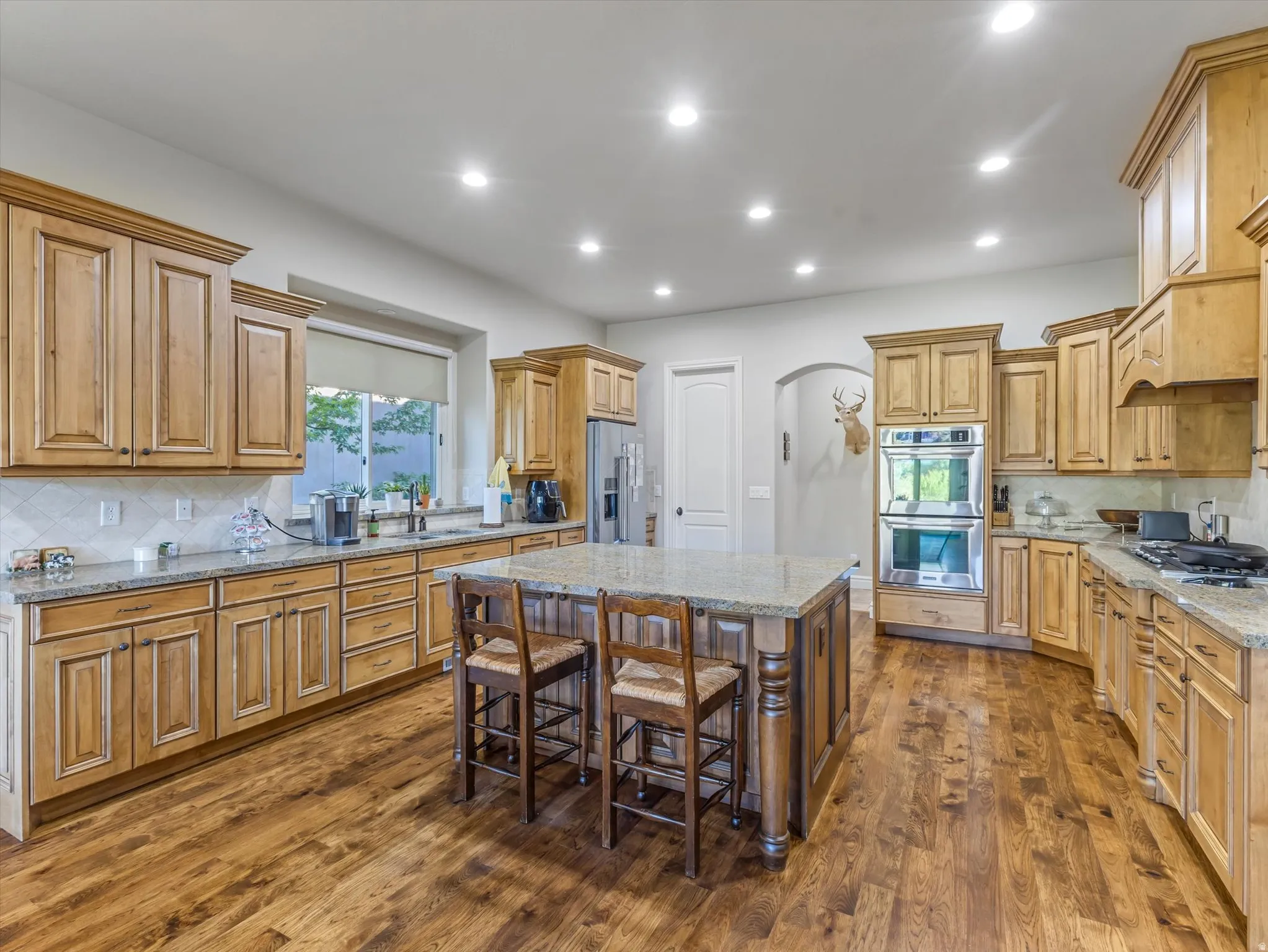 Stylish kitchen with wood cabinets and granite counter tops
