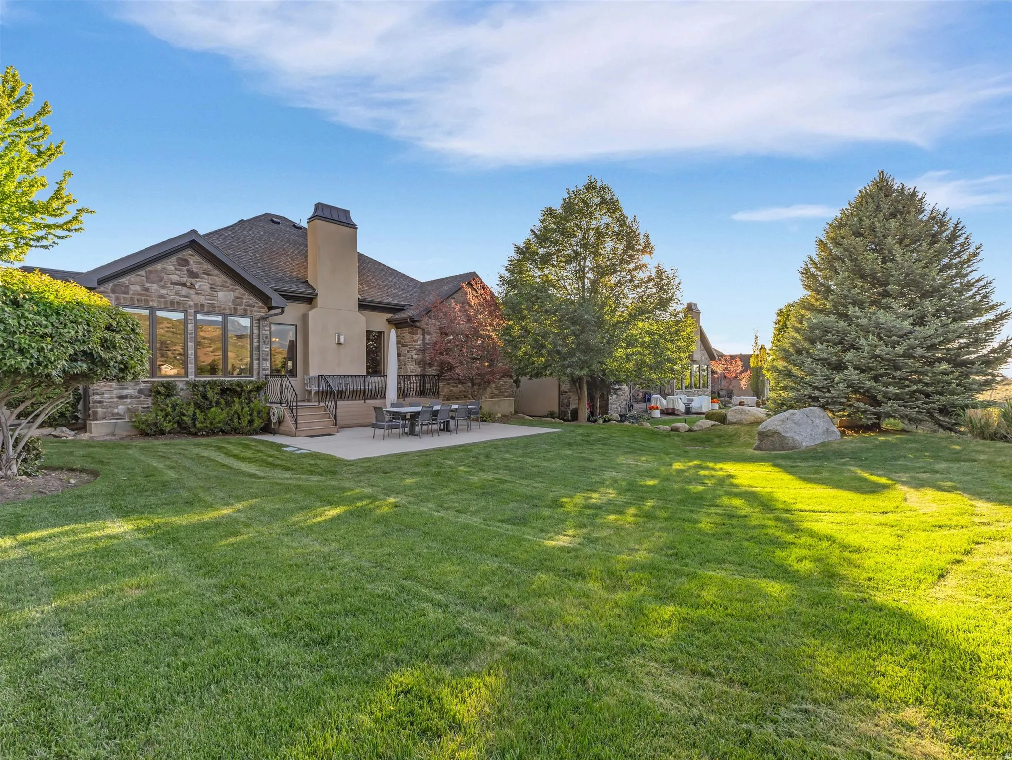 View of back of home with large grassy area