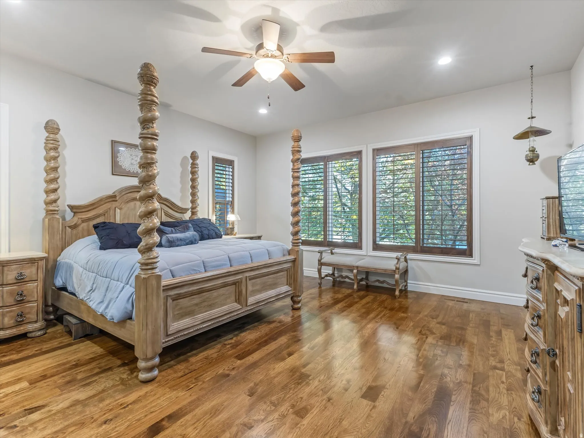 Owner's suite with beautiful hard wood floors and wood plantation shutters