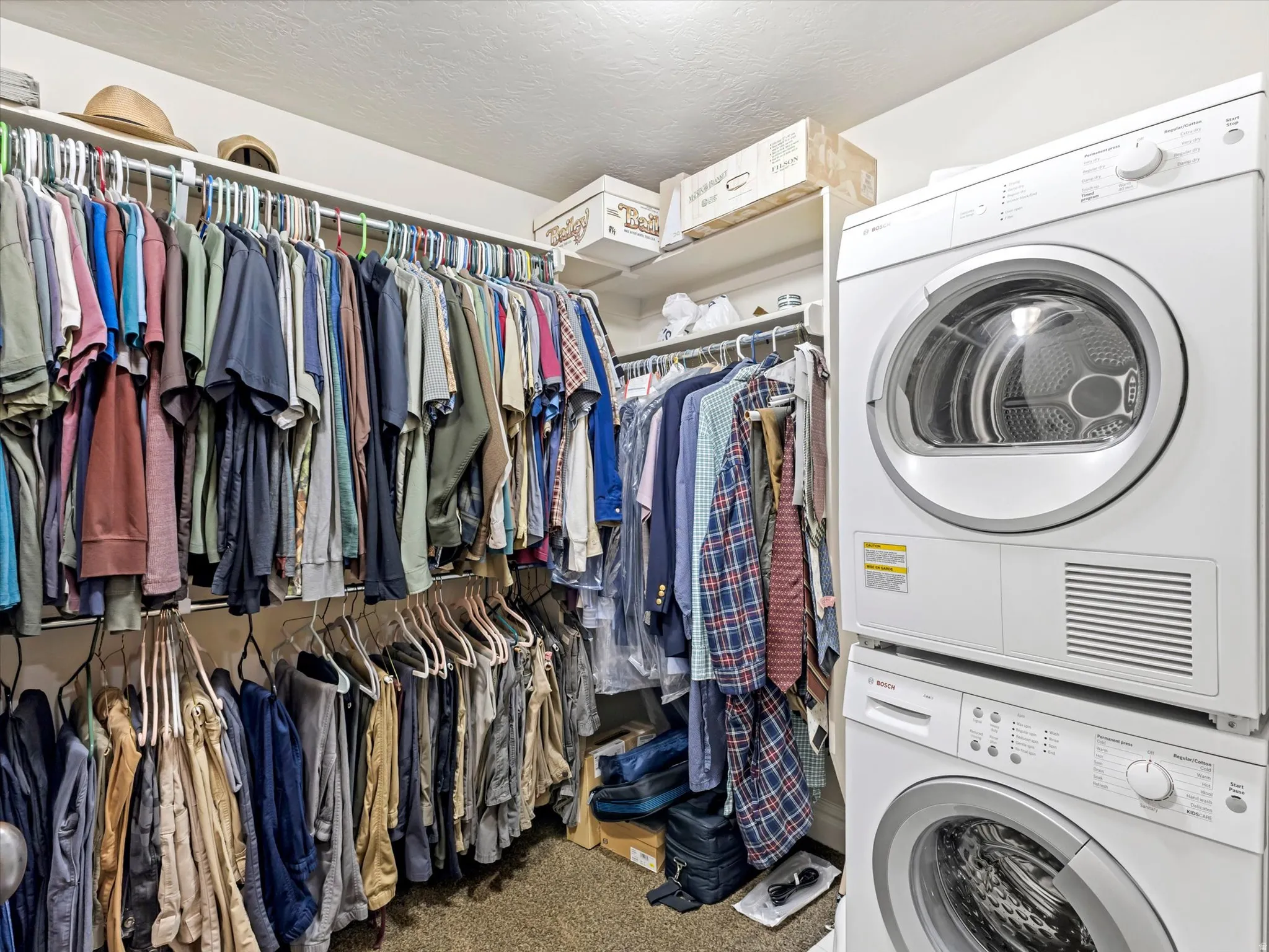 Walk in closet with private laundry area