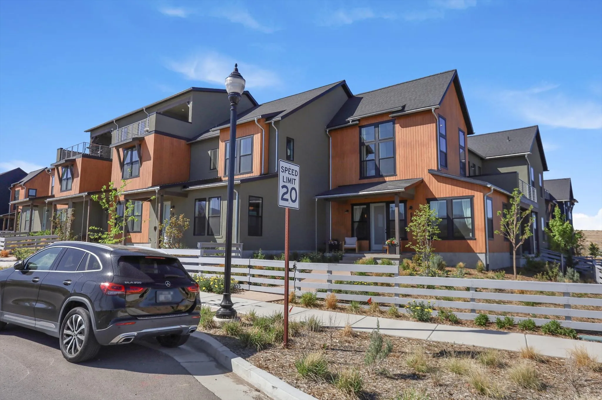 Contemporary residences featuring multi-toned siding, pitched roofs, and multiple large windows