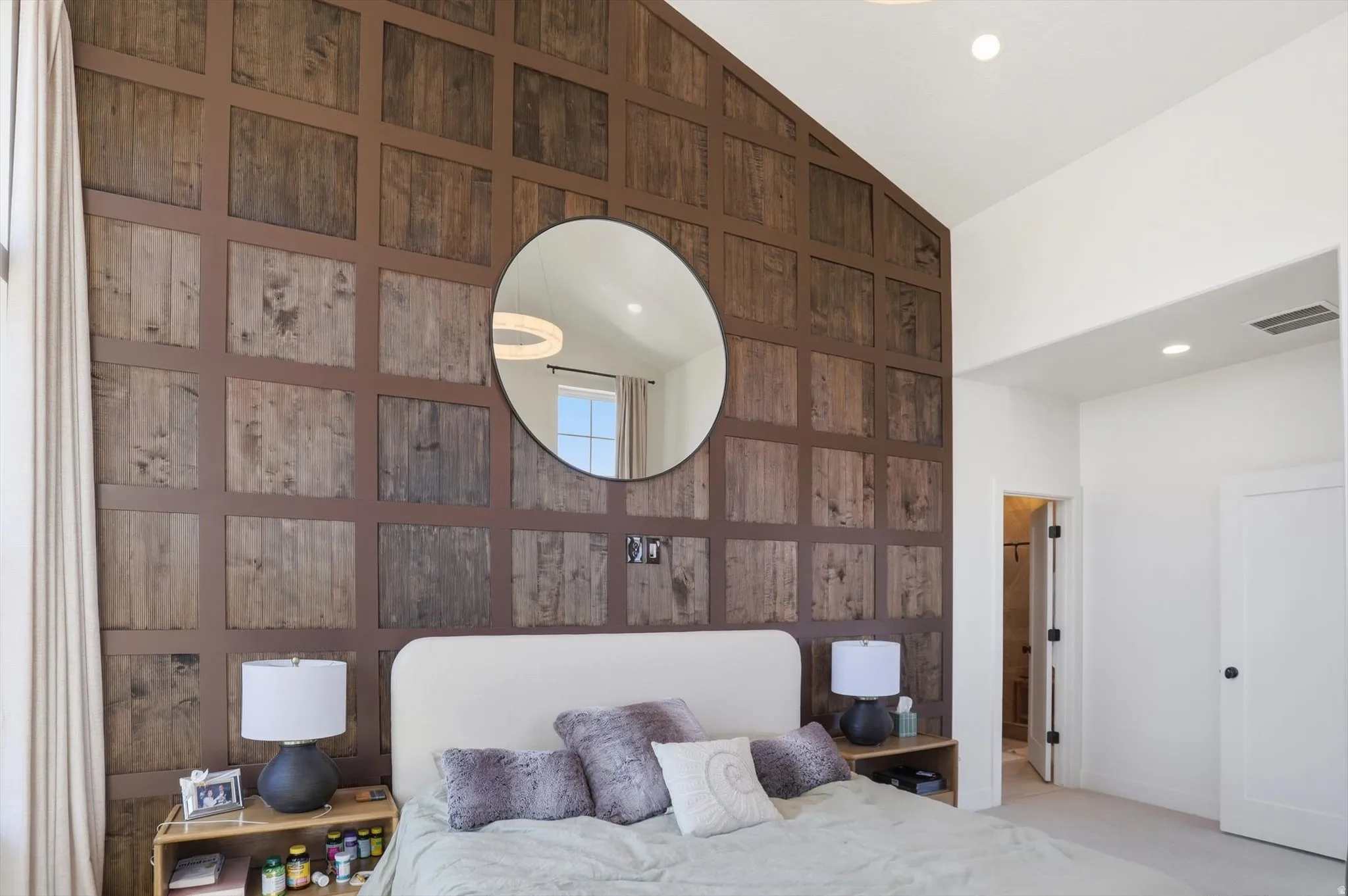 Accent wall featuring a wood-panel design and vaulted ceilings