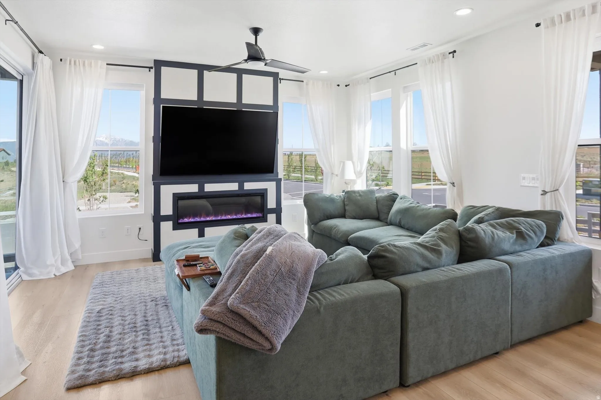 Living area featuring wood-finish flooring and multiple windows