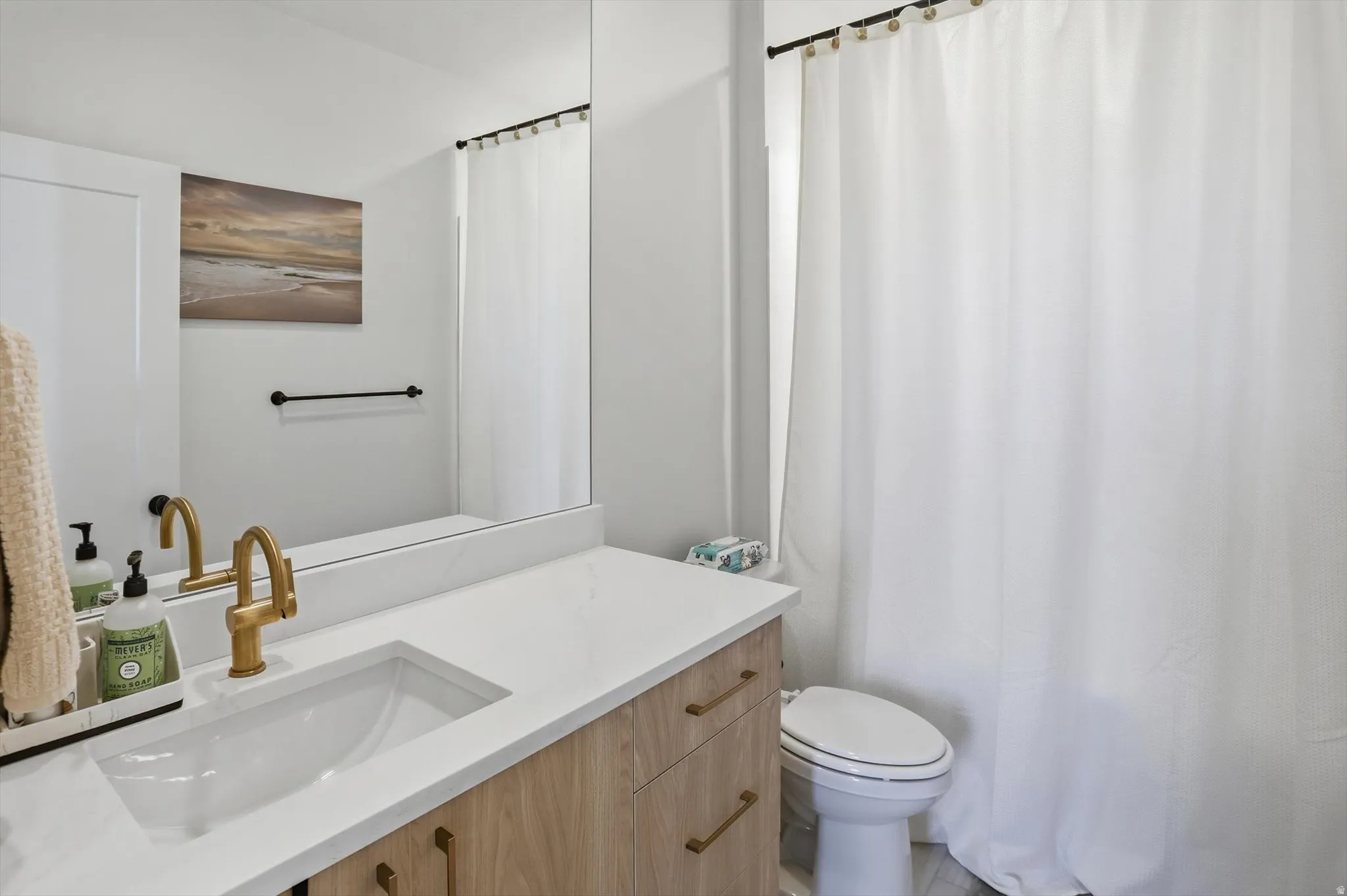 Bathroom vanity with a white countertop and integrated rectangular sink