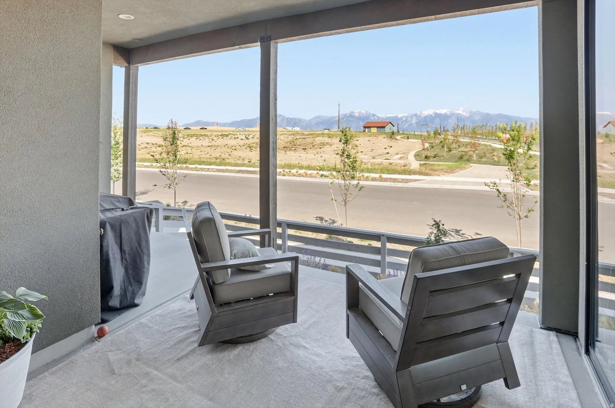 Covered patio space featuring a concrete floor and a stucco exterior wall