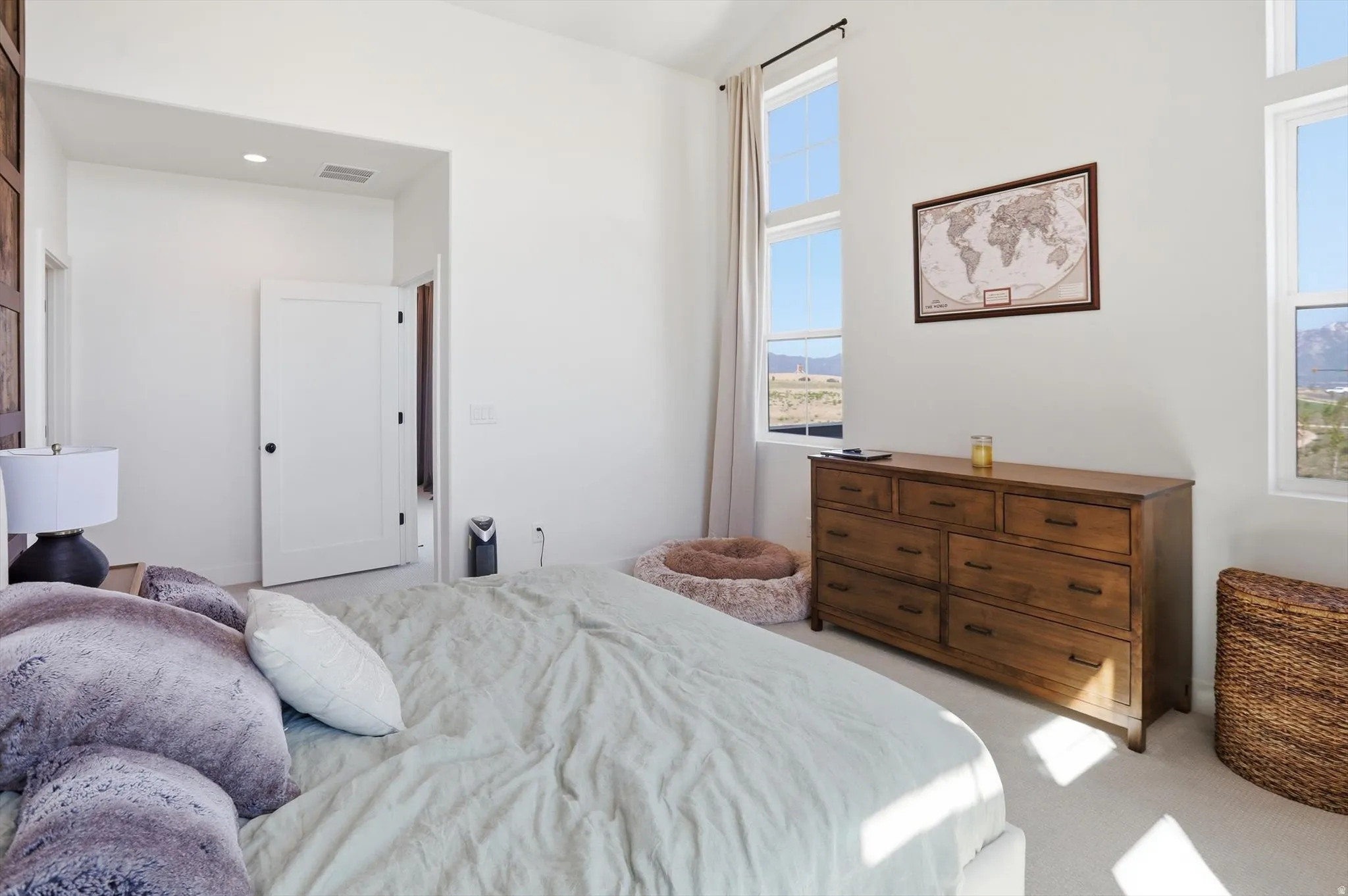 White walls featuring multiple tall windows with mountain scenery