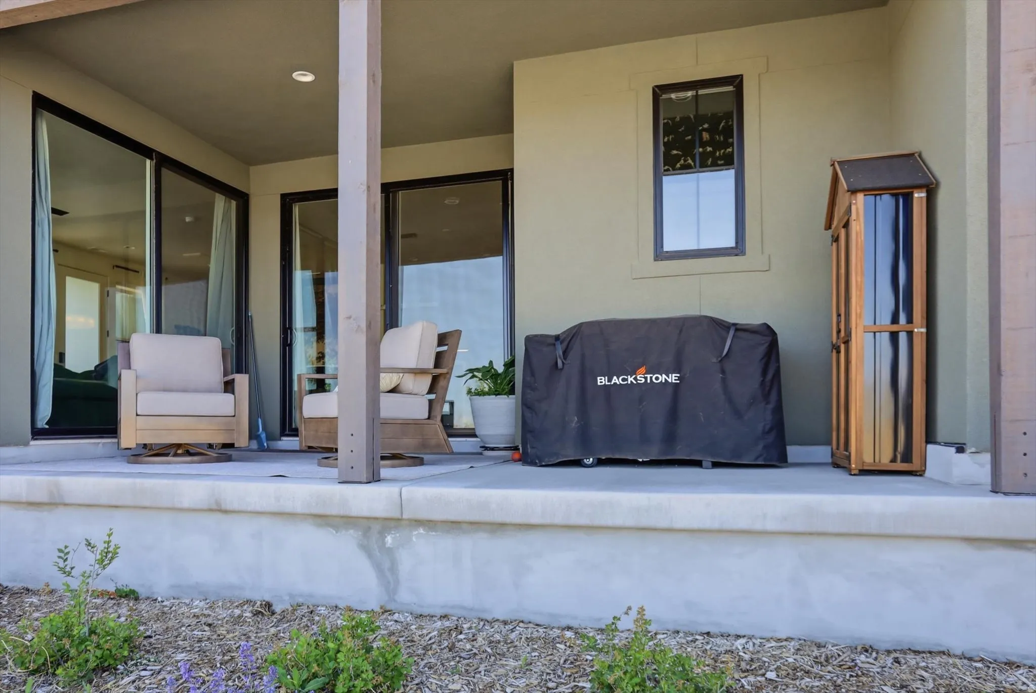 Covered patio featuring a concrete slab and painted siding
