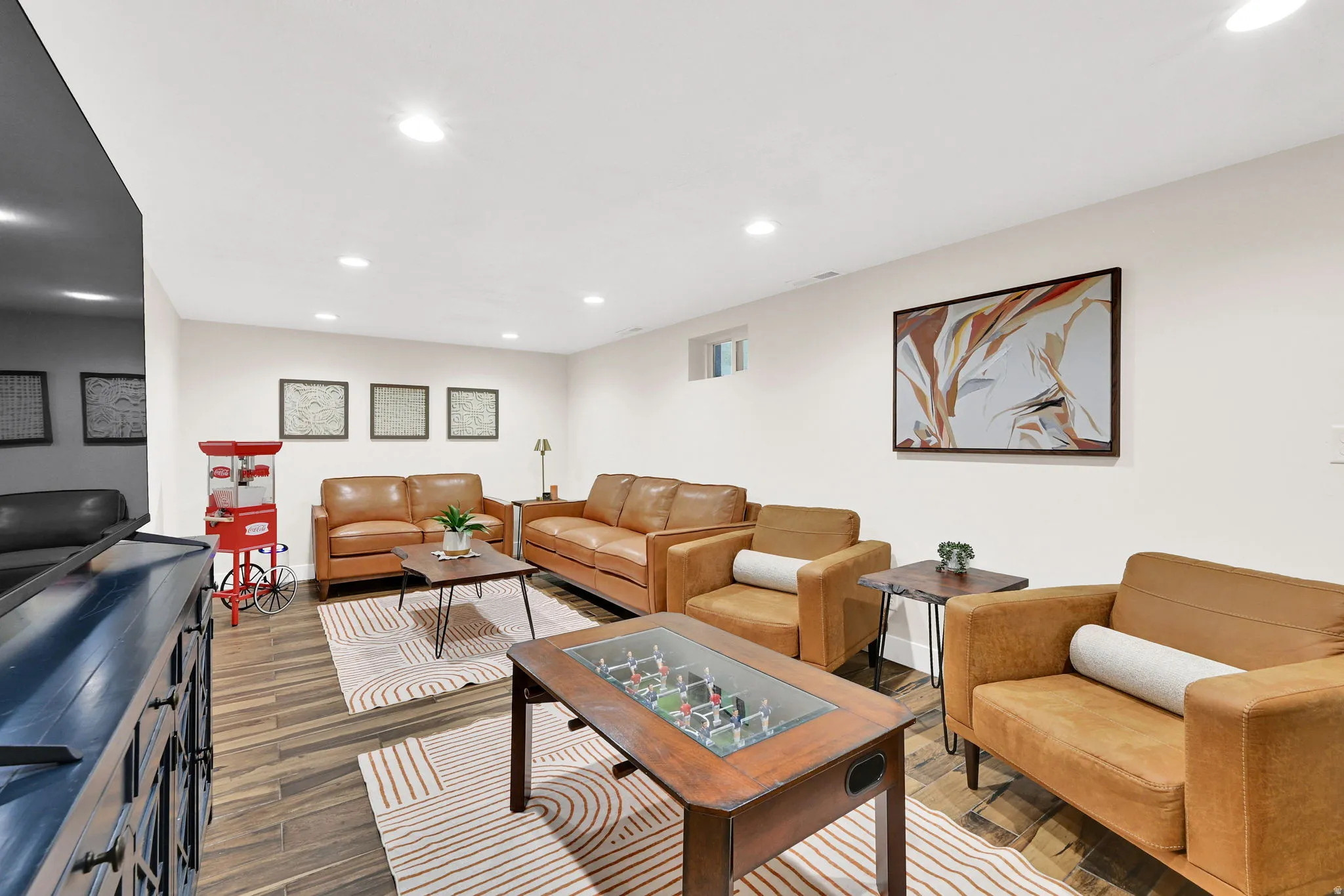 Spacious room featuring tile flooring, recessed lighting, and a neutral color palette