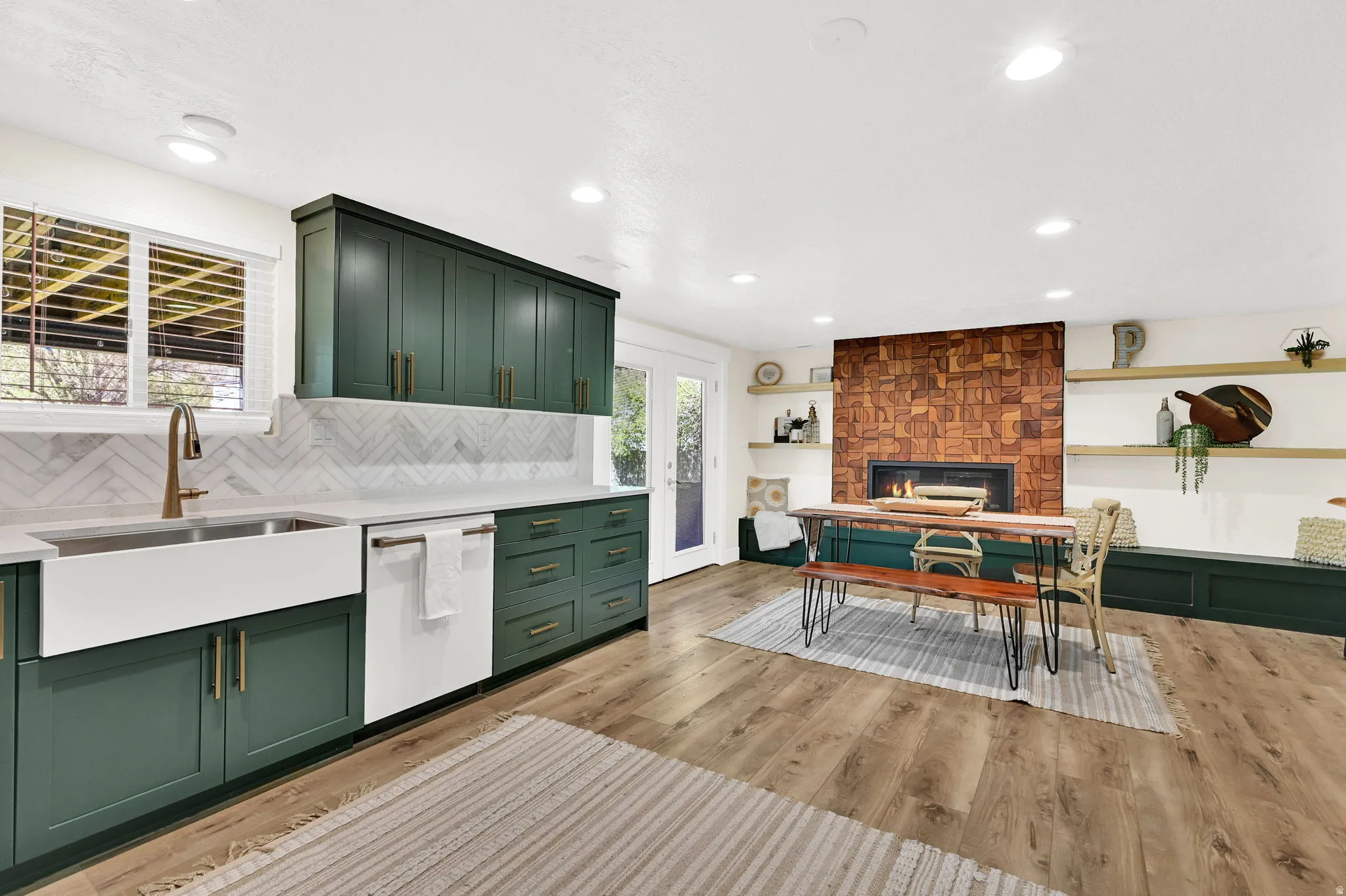 Open-concept living space with wood-finish flooring and custom teak fireplace
