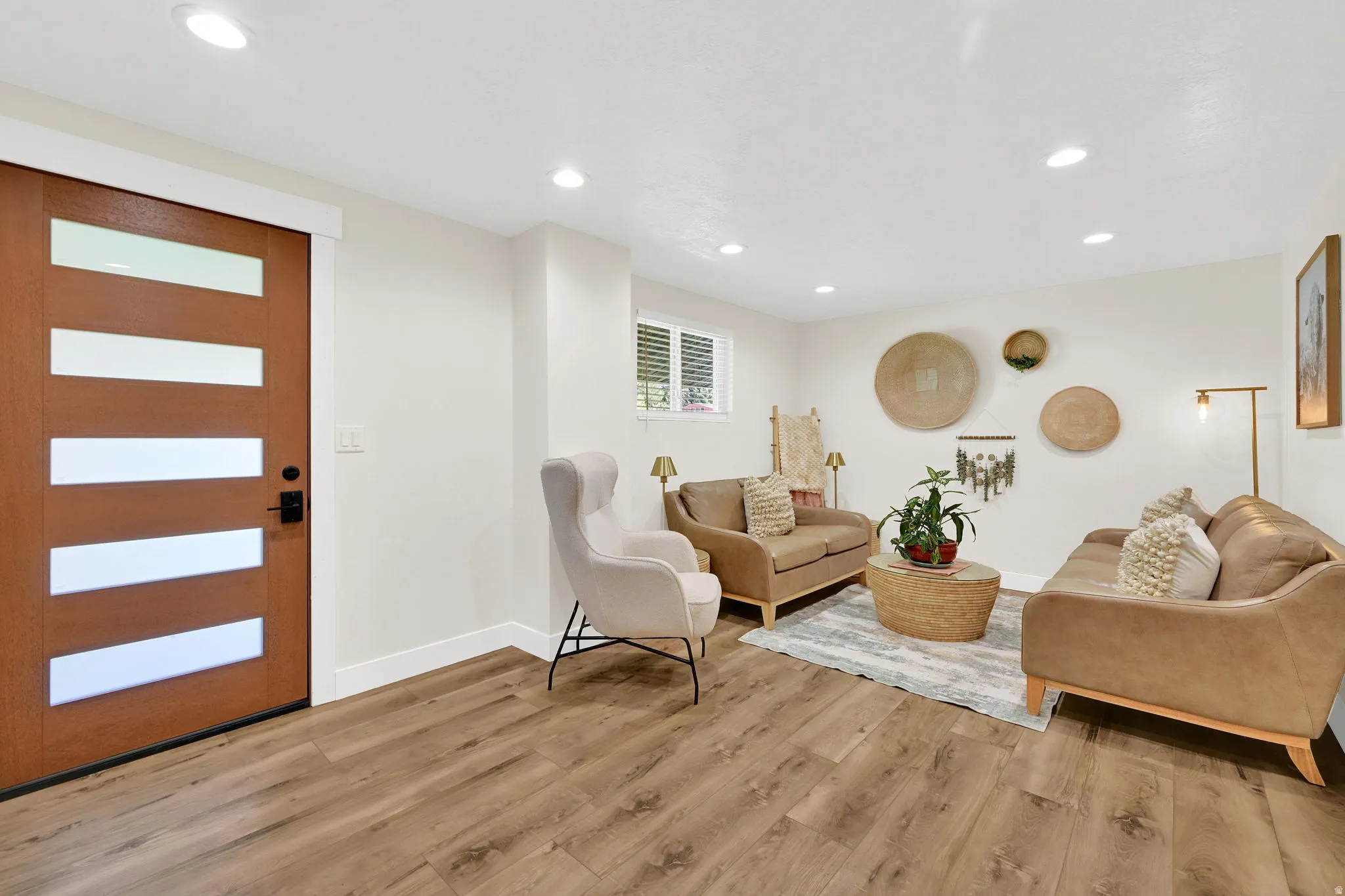 Contemporary wood-finish flooring complements the bright white walls and recessed ceiling lighting
