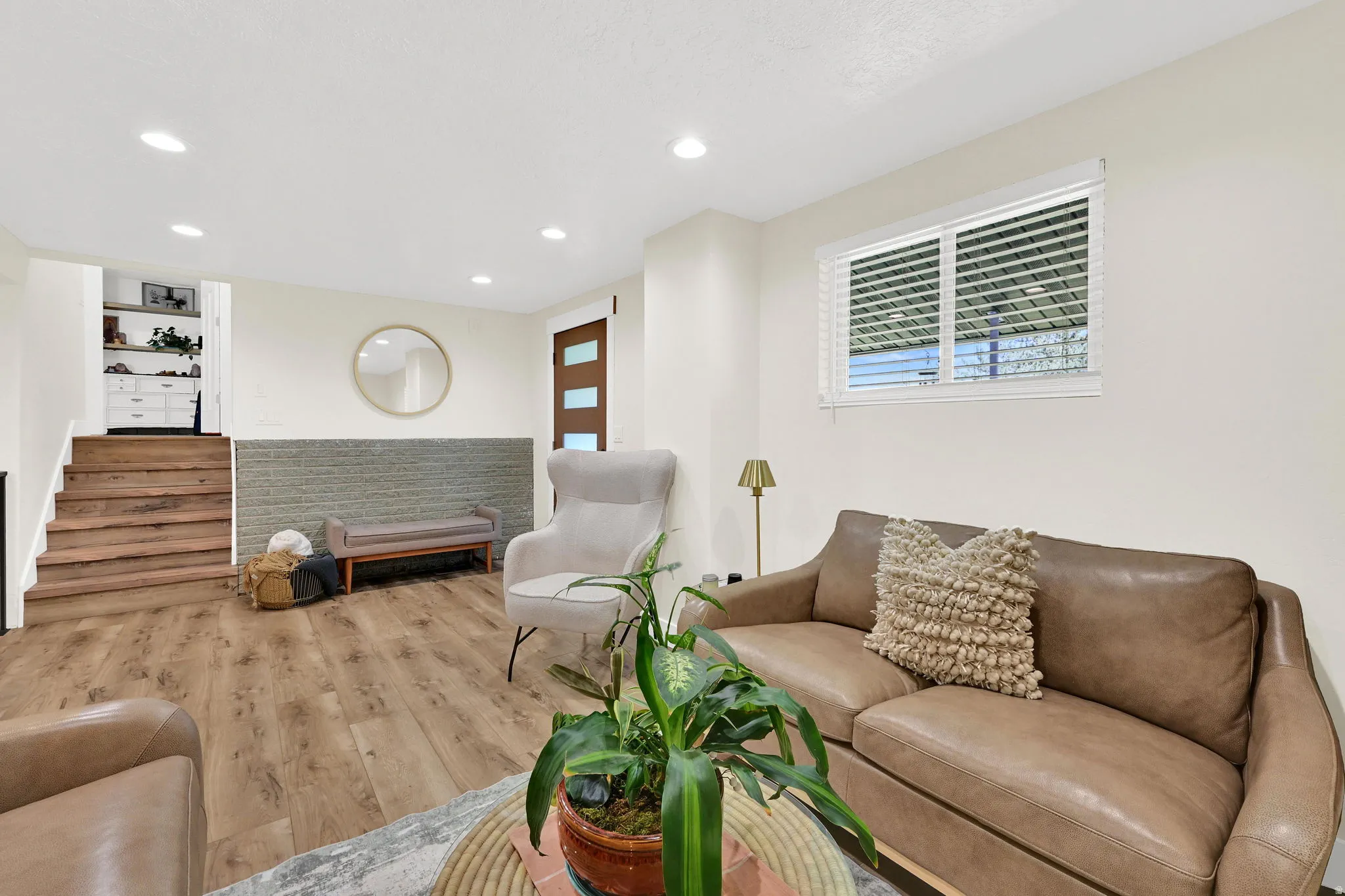 Spacious living area featuring recessed lighting, wood-finish flooring, and a window with horizontal blinds