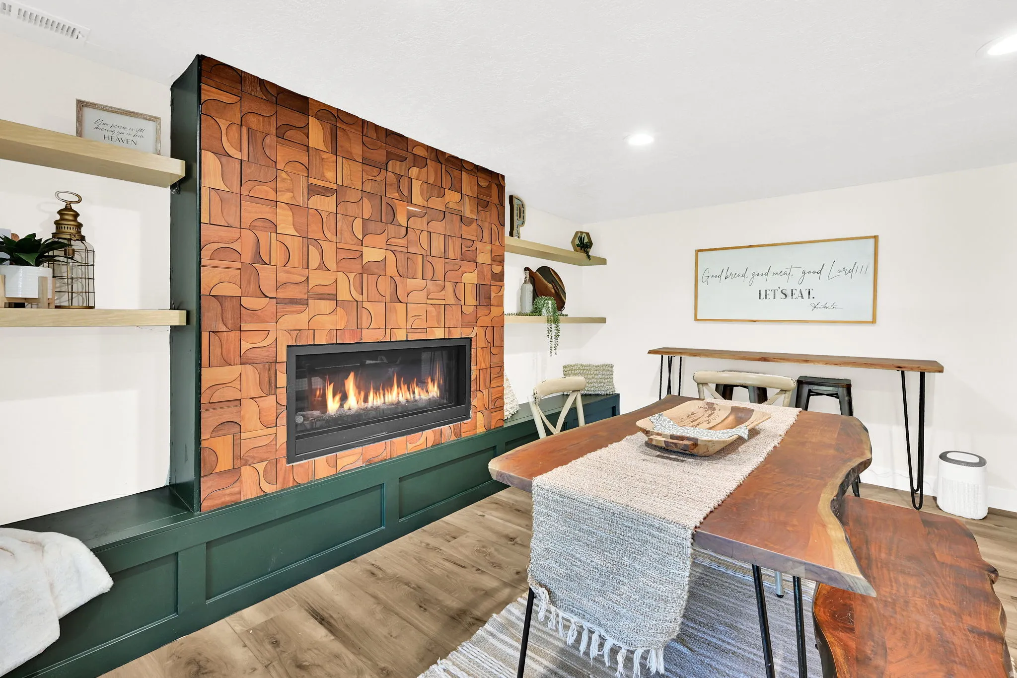 Feature wall showcasing a linear fireplace set with custom teak wood tiles.
