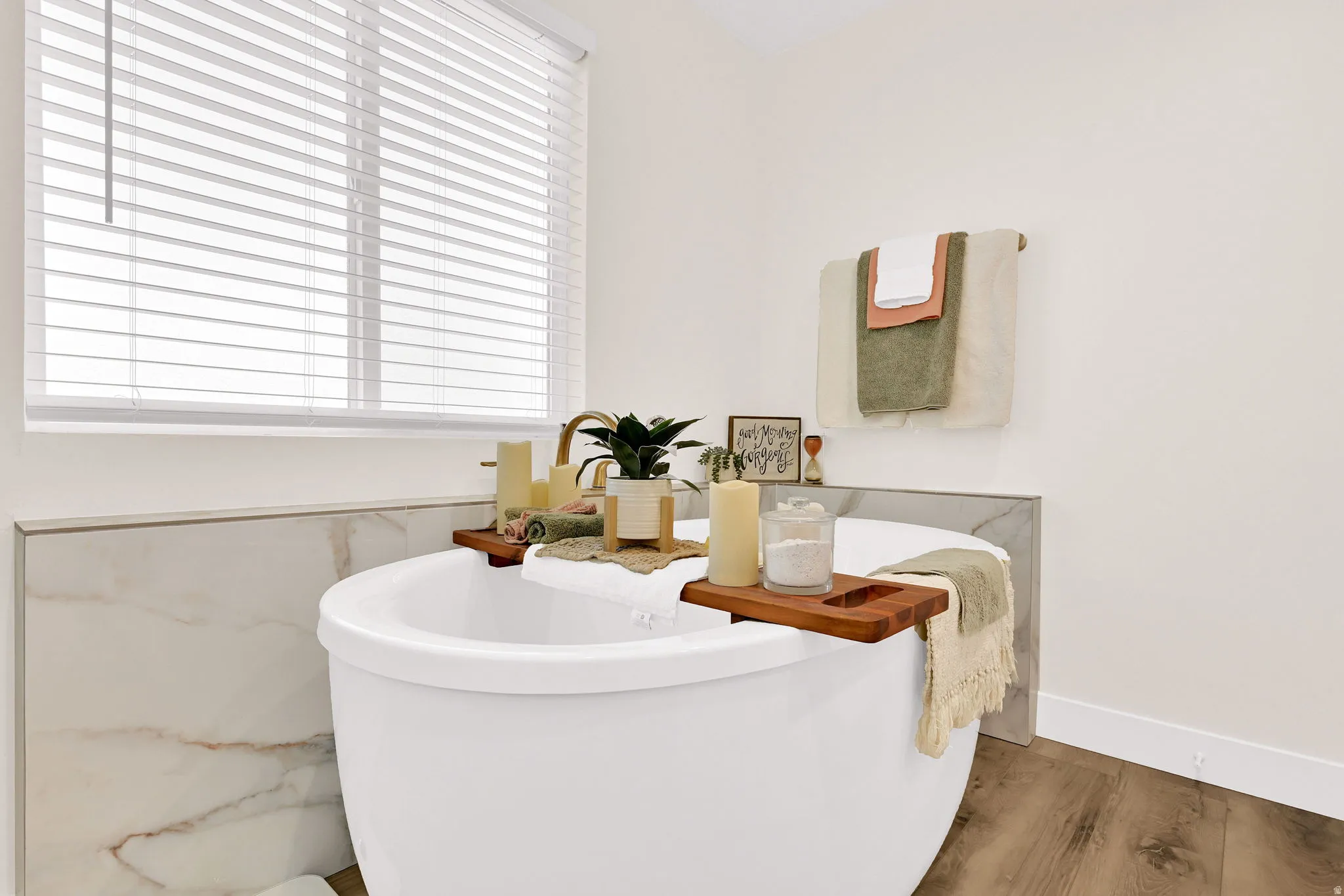 Primary en-suite with freestanding soaker tub, dual-headed shower, and water closet offers a spa-like feel