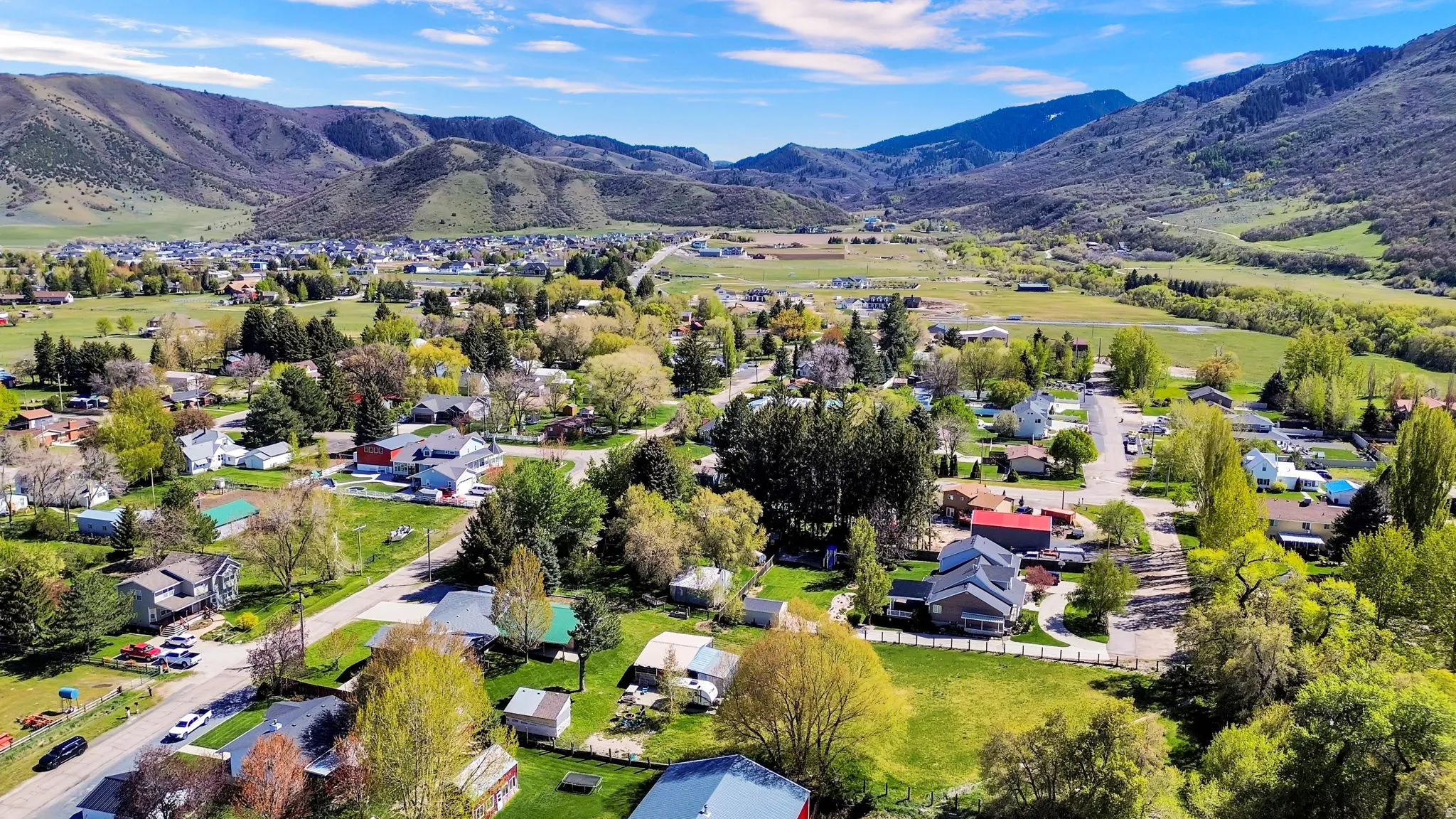 Expansive aerial overview showcasing a residential area amidst a mountainous landscape