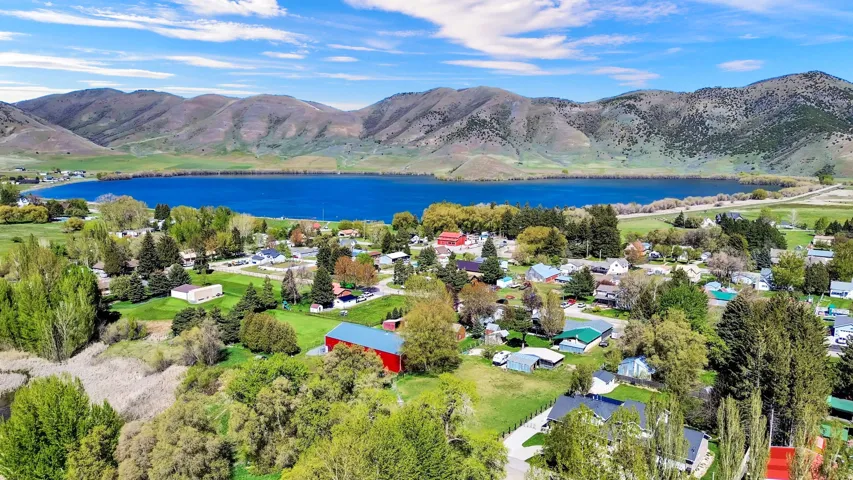 Expansive lakefront community featuring a deep blue lake and surrounding mountains
