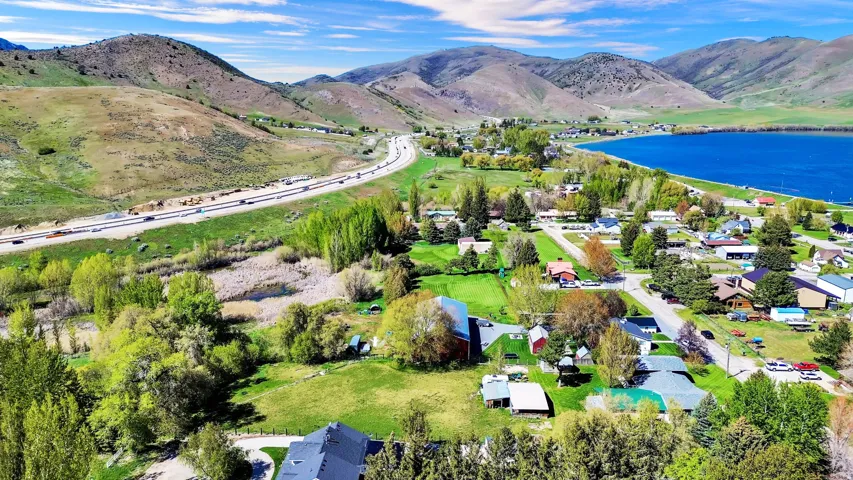 Expansive aerial showcasing a lakeside community with surrounding mountains