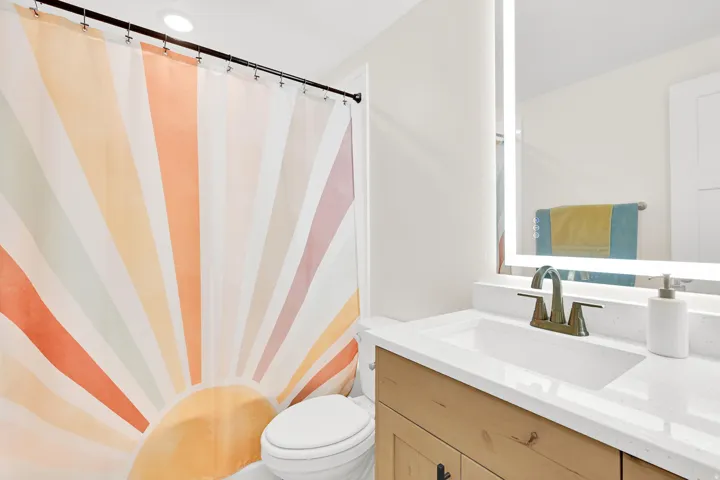 Bathroom featuring a light wood-finish vanity with a white countertop and integrated sink