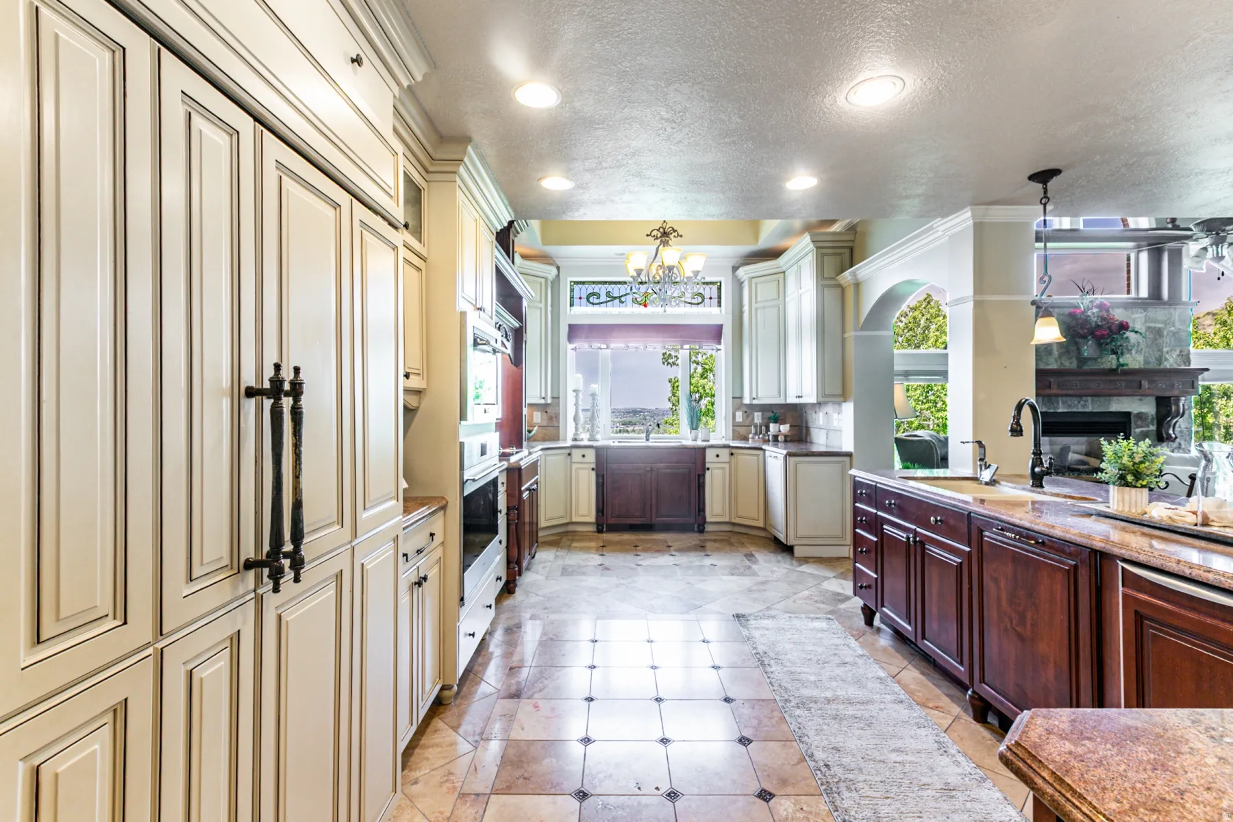 Spacious kitchen featuring an integrated refrigerator, recessed lighting, and a two-toned cabinetry scheme, two sinks and two dishwashers.