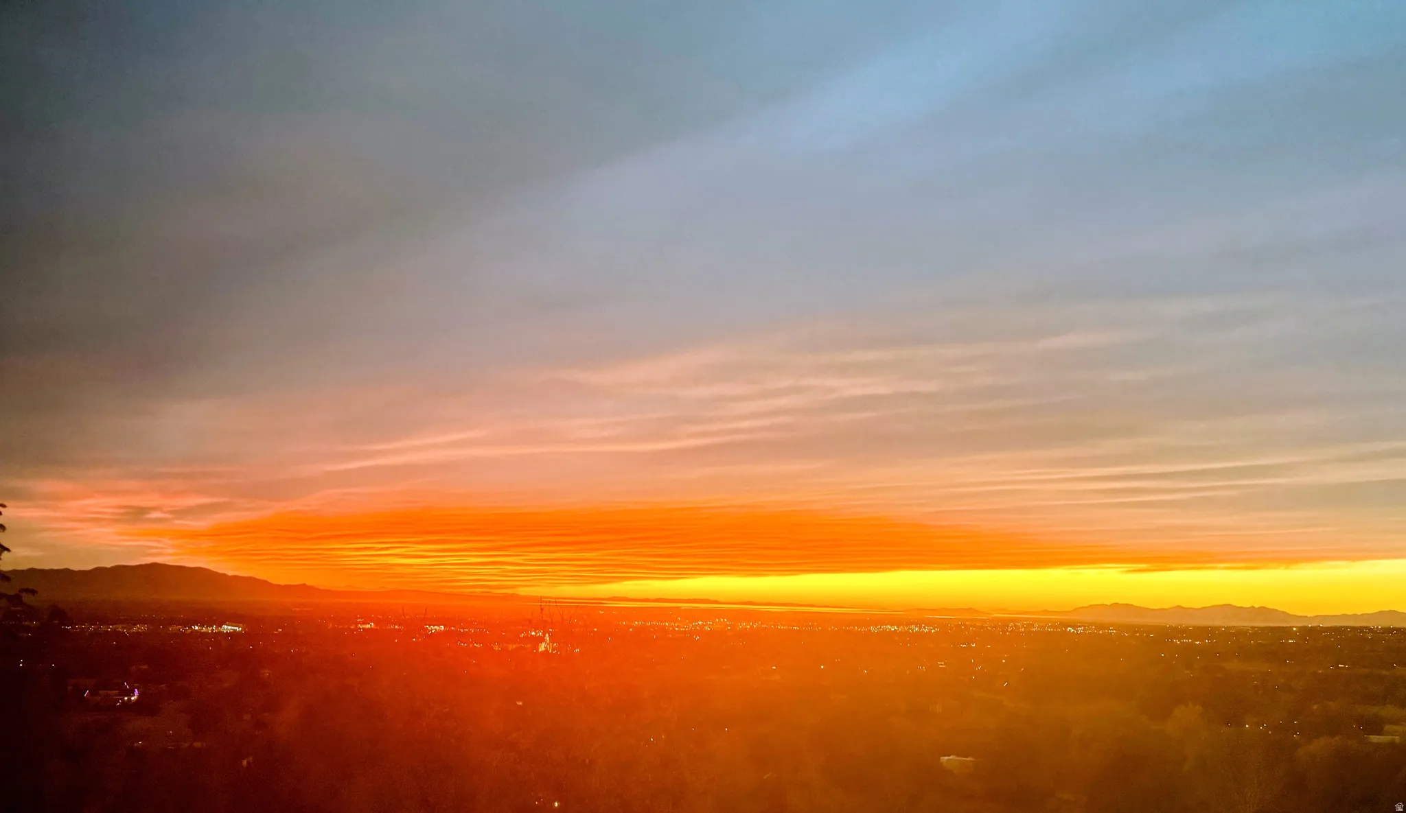 Expansive city backdrop beneath a vibrant horizon