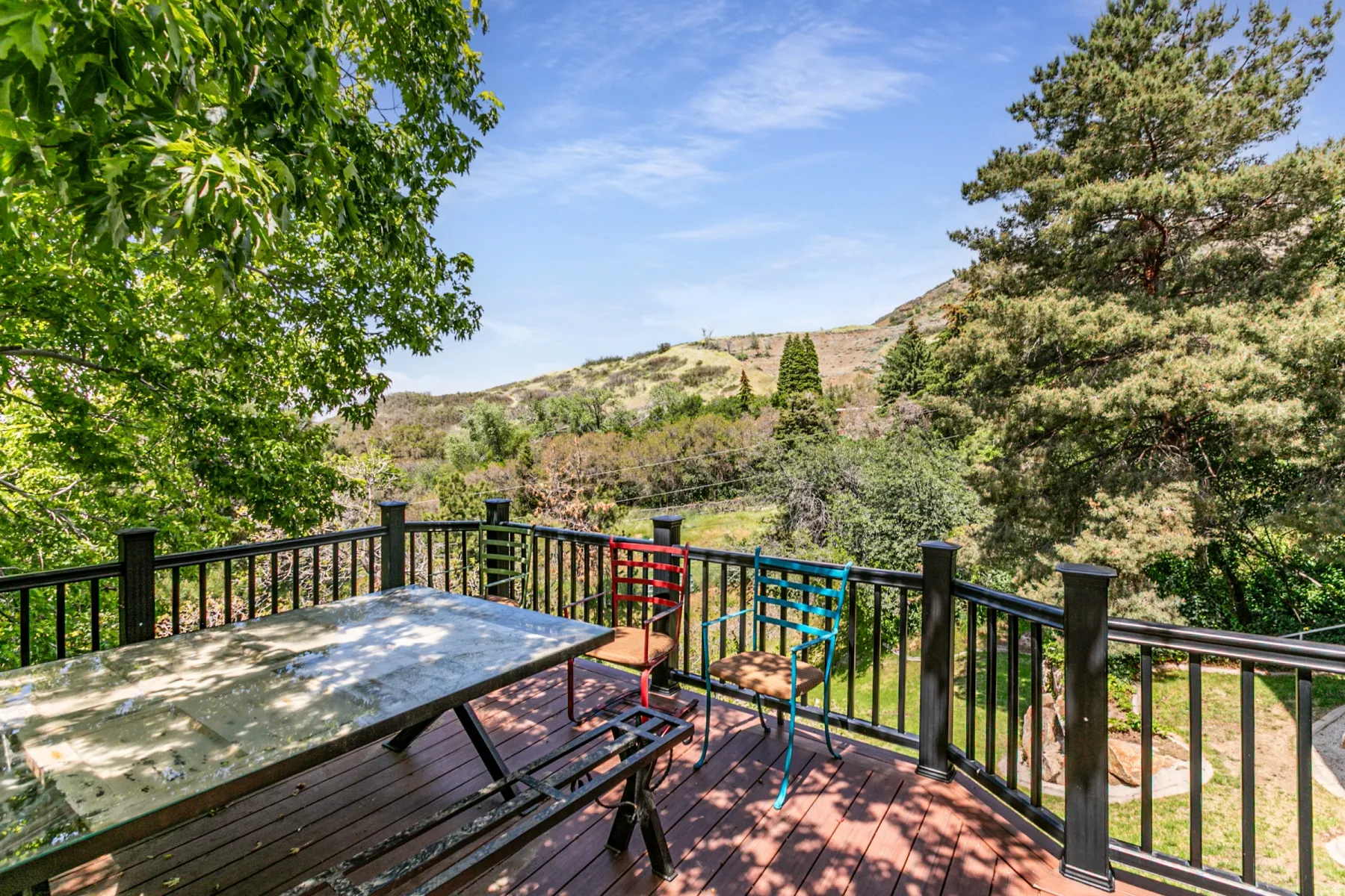 Expansive outdoor deck featuring composite decking and black metal railings