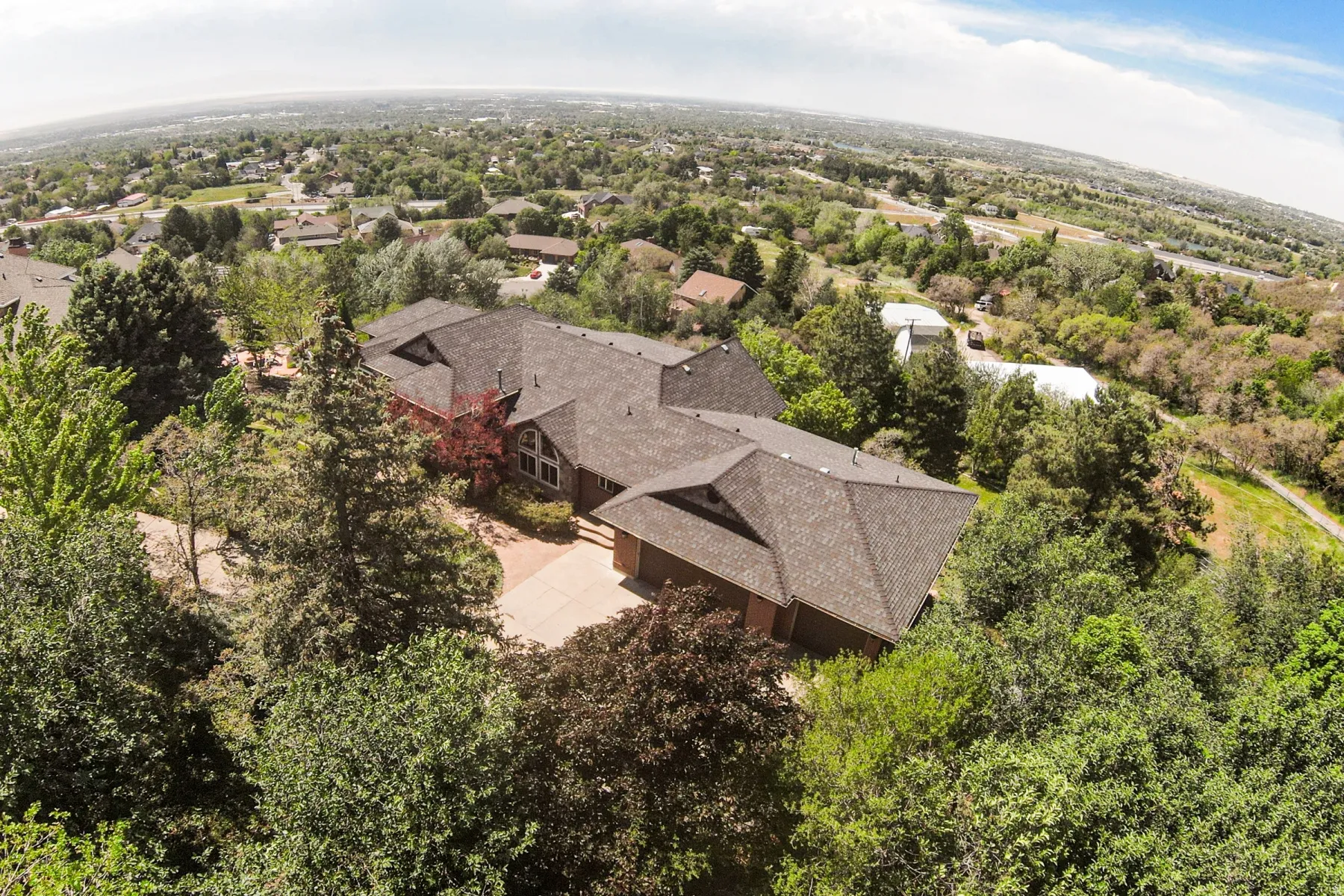 Expansive residential property featuring a multi-gabled roofline and a brick facade