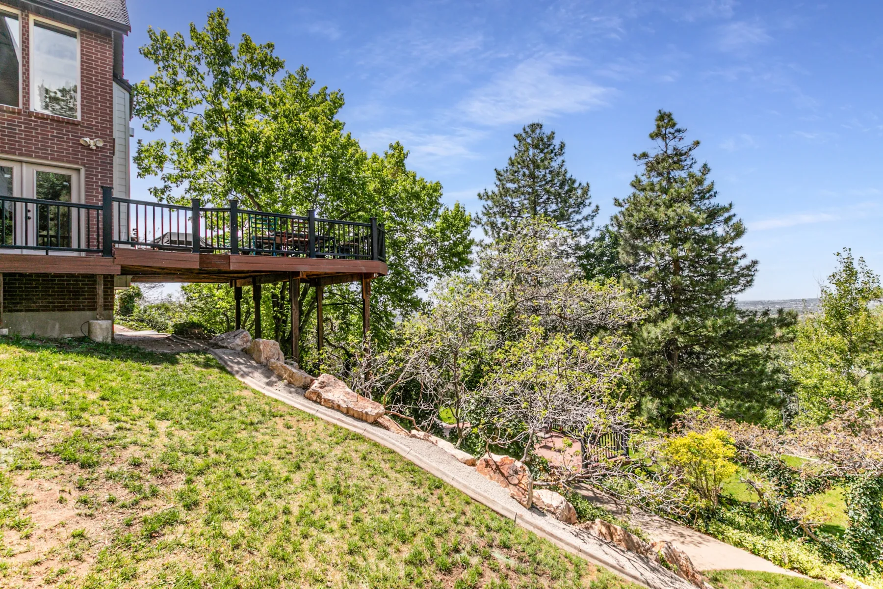 Elevated wood-finish deck with black spindle railing and double door access