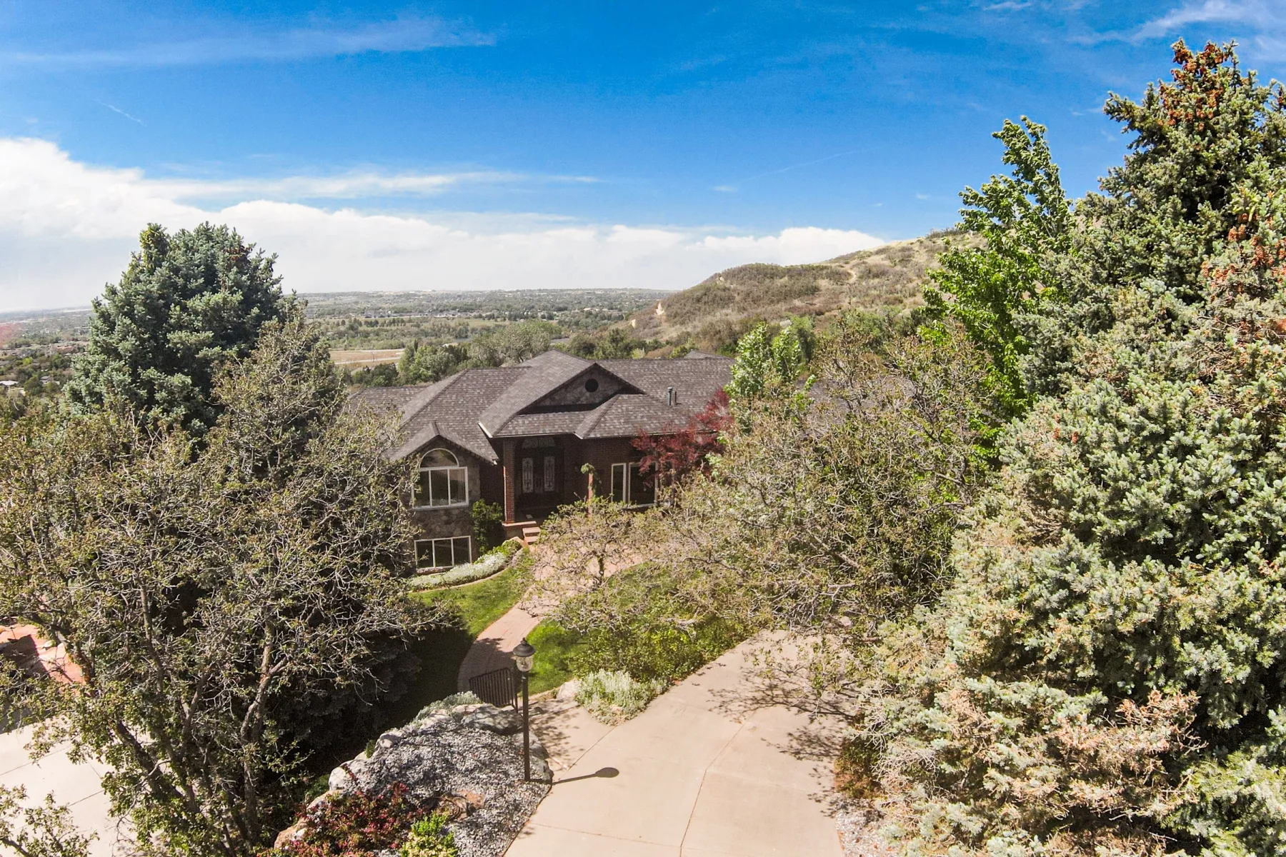 The property features a multi-level roofline, a stone facade, and a bay window