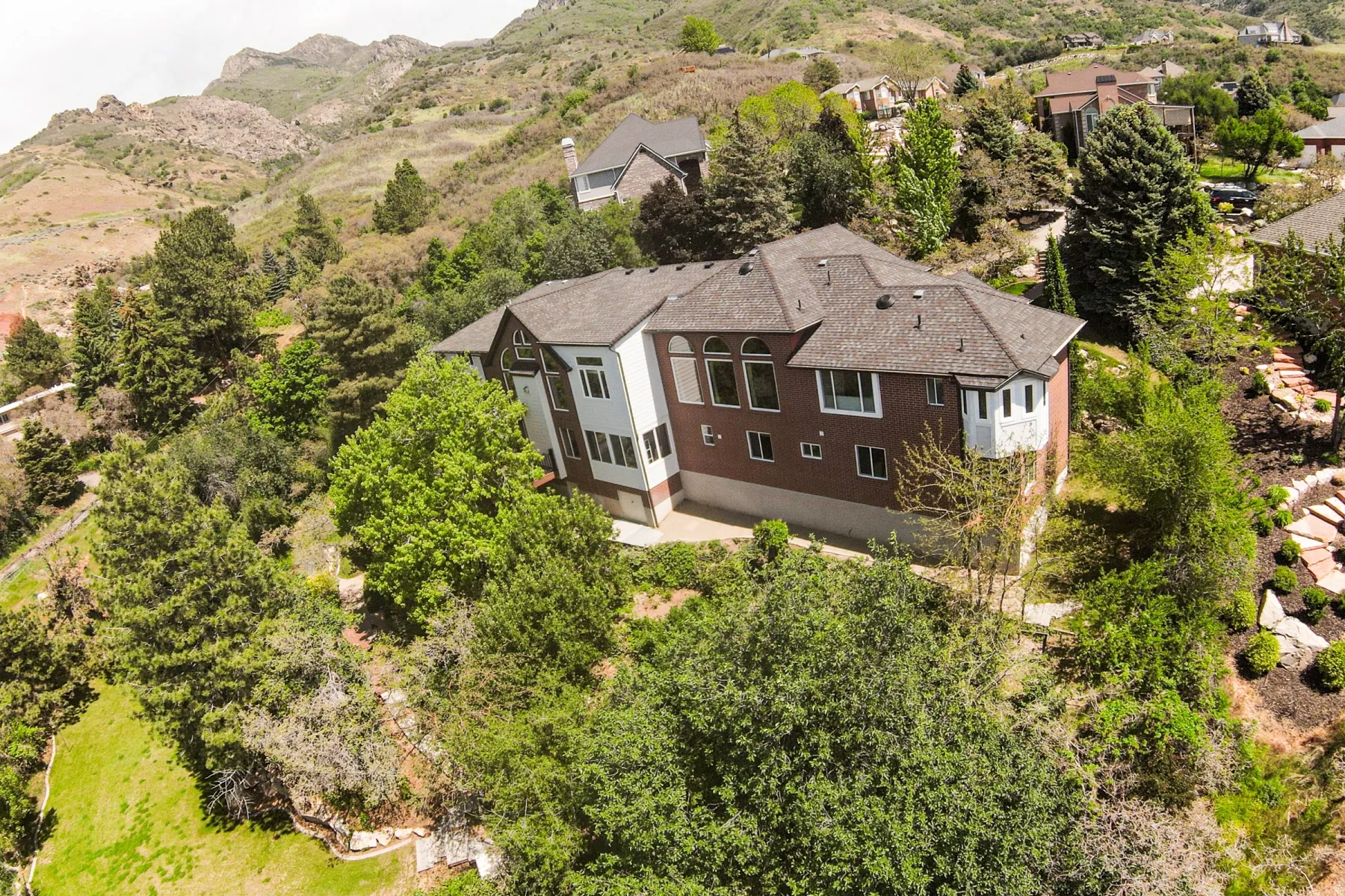 Hillside residence featuring a multi-level design and expansive landscaping