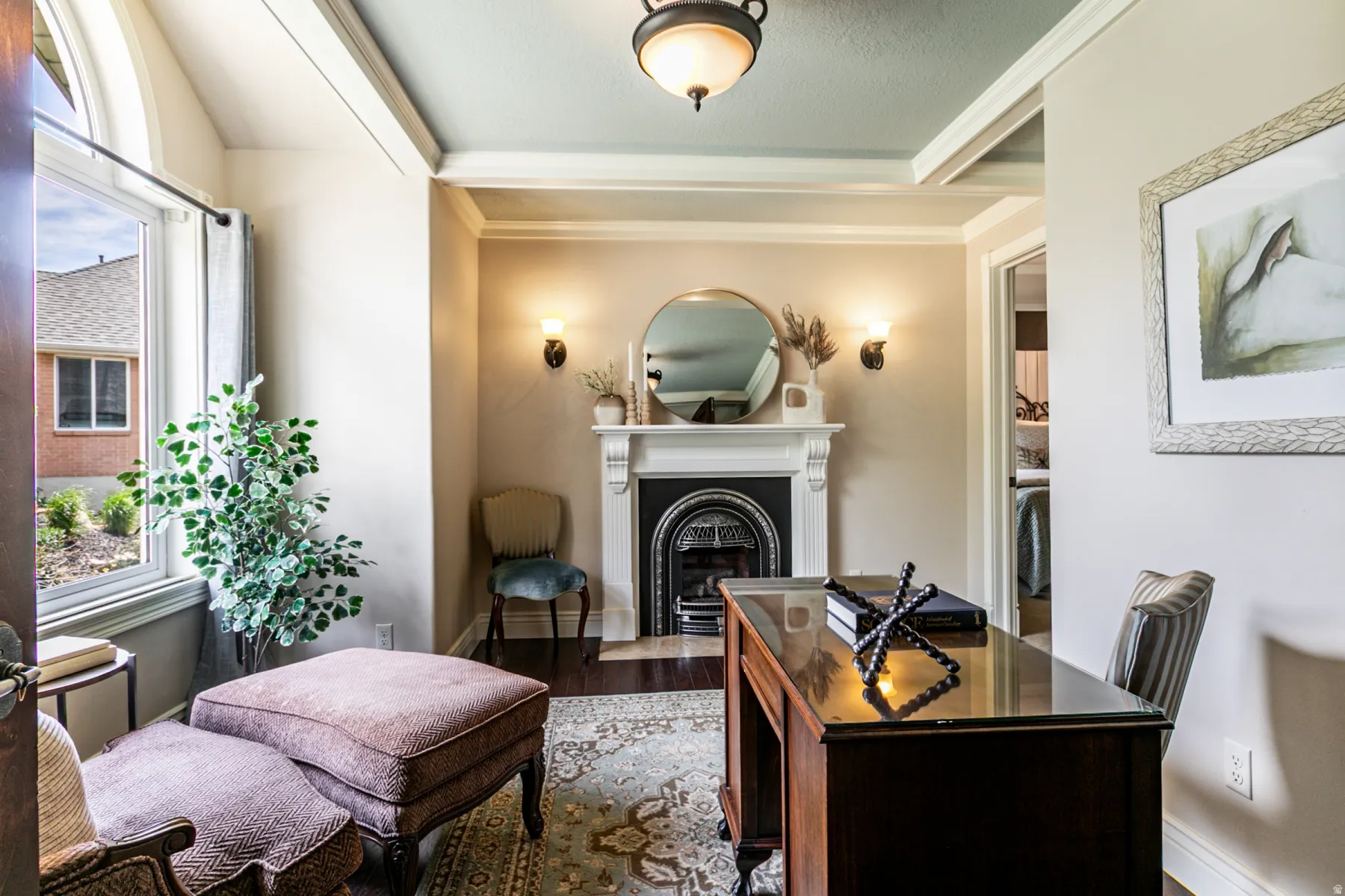 Formal room featuring a decorative fireplace with a black iron insert, a white mantel, and dark wood-finish flooring