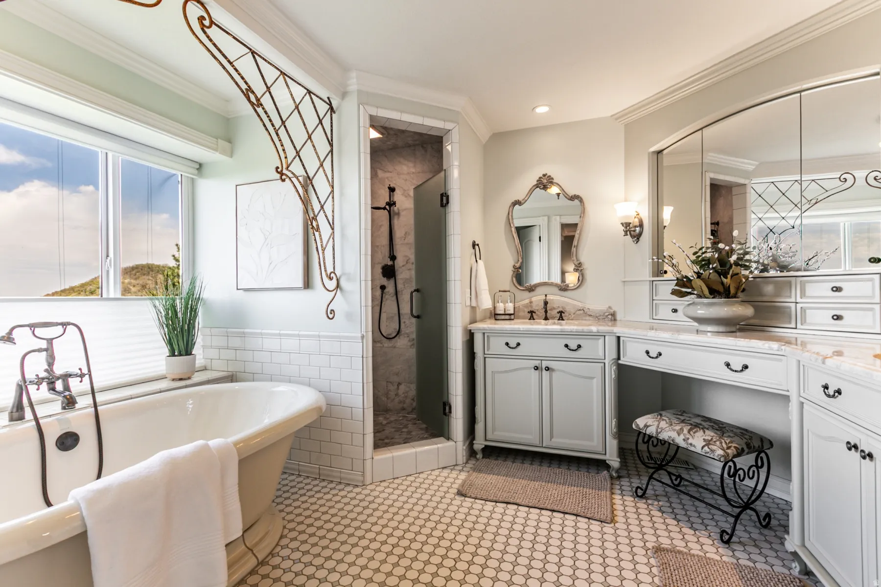 Freestanding soaking tub with floor-mounted faucet, complemented by a walk-in shower with a glass door